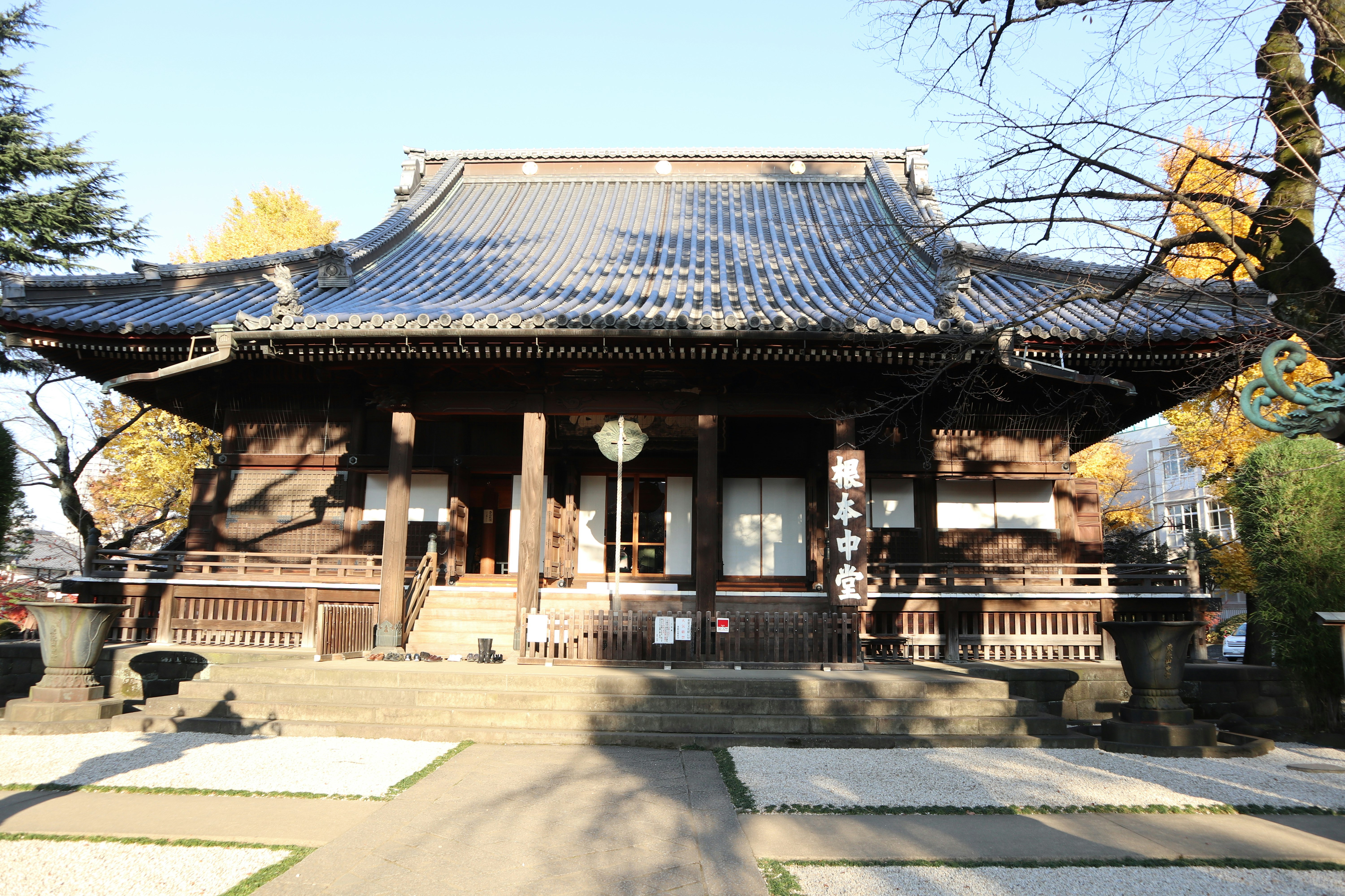 wooden temple building and stone steps in the courtyard