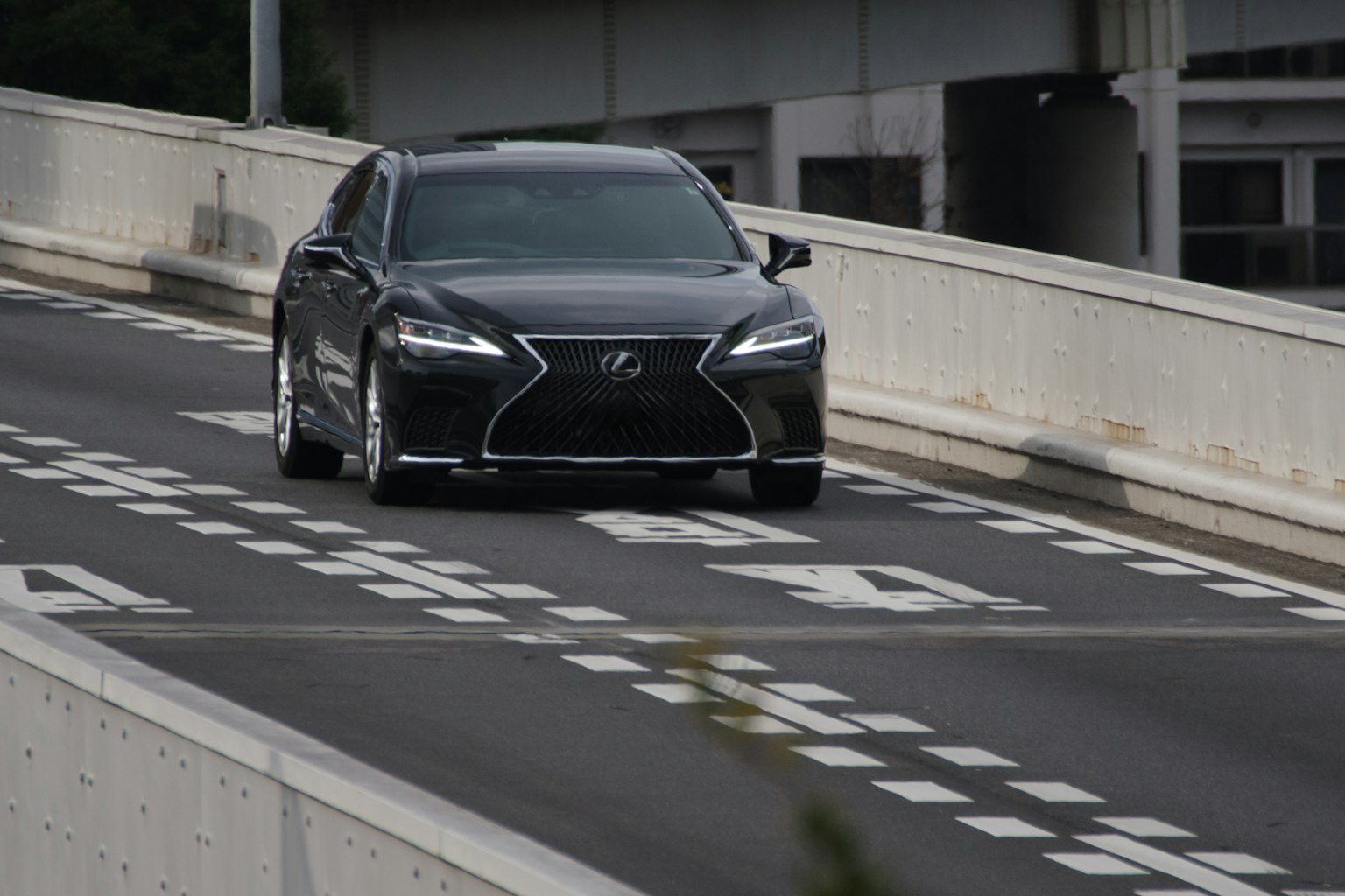Black Lexus car driving on the road