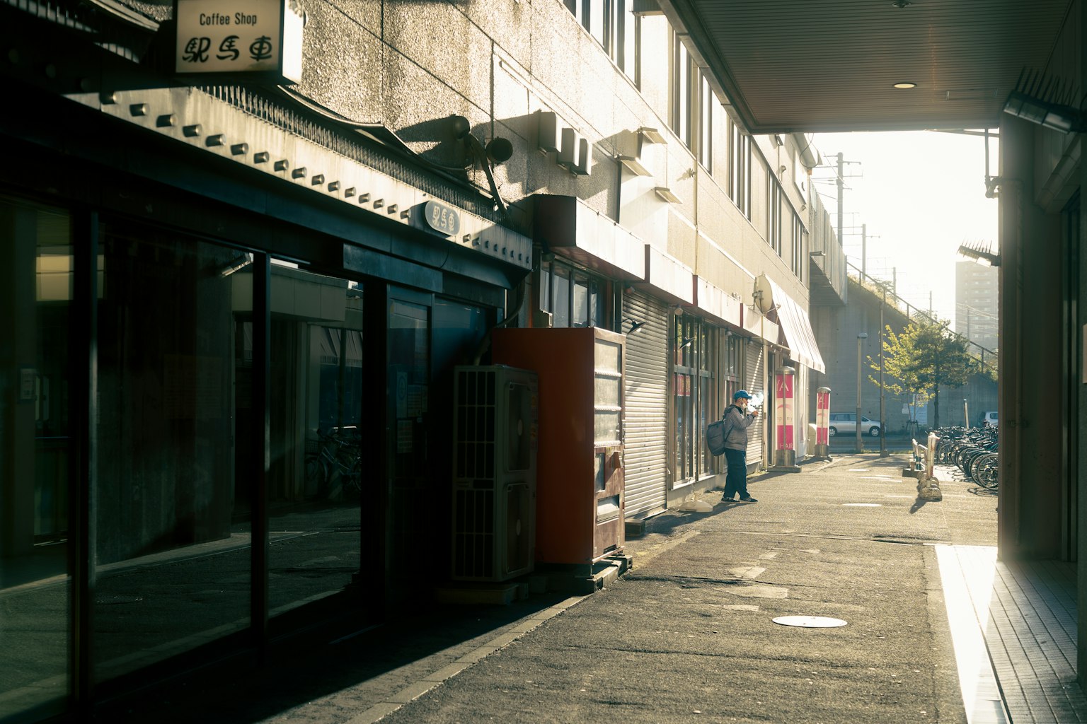 Image of a quiet street with shops and people