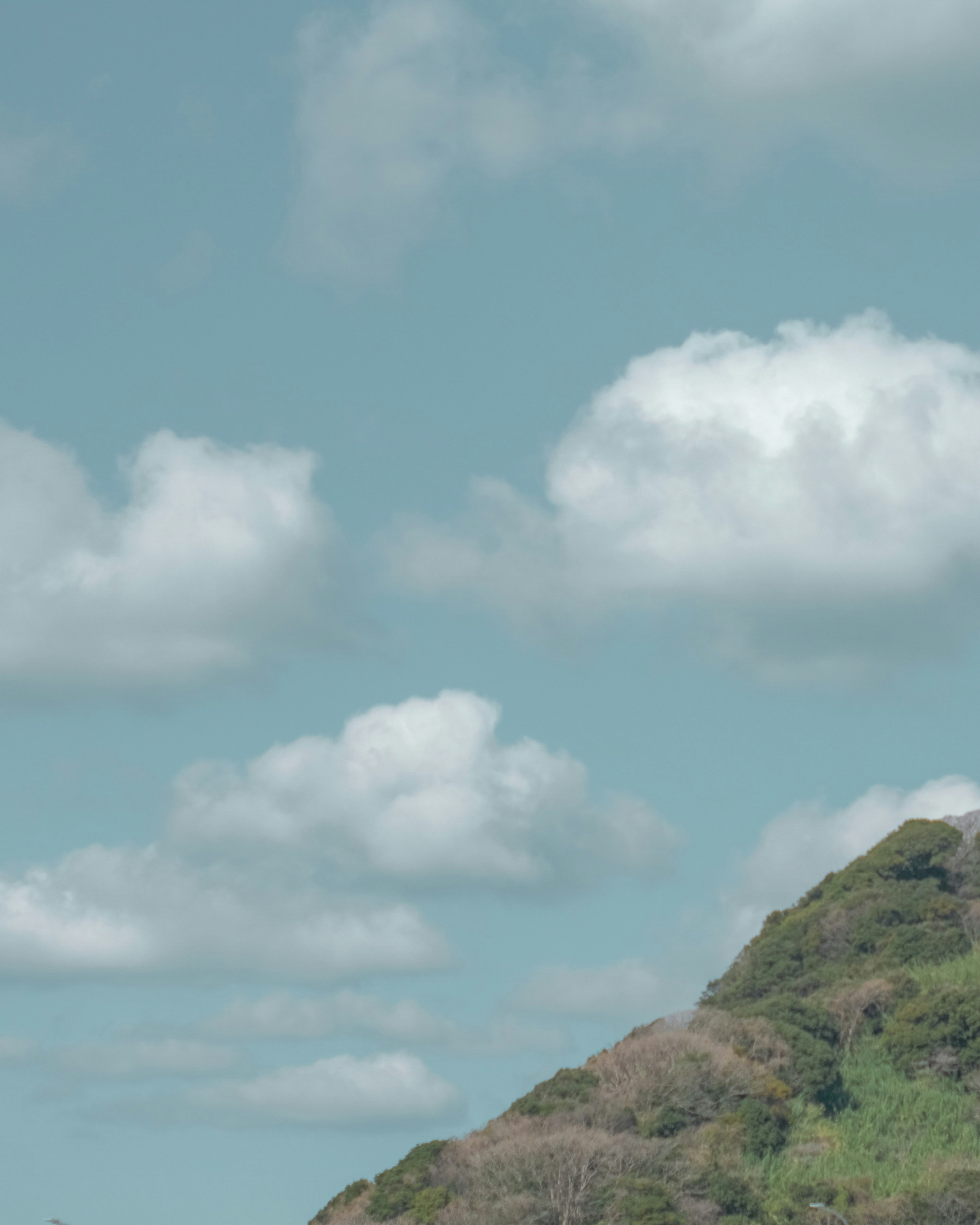 sky with clouds and a hillside mountain view