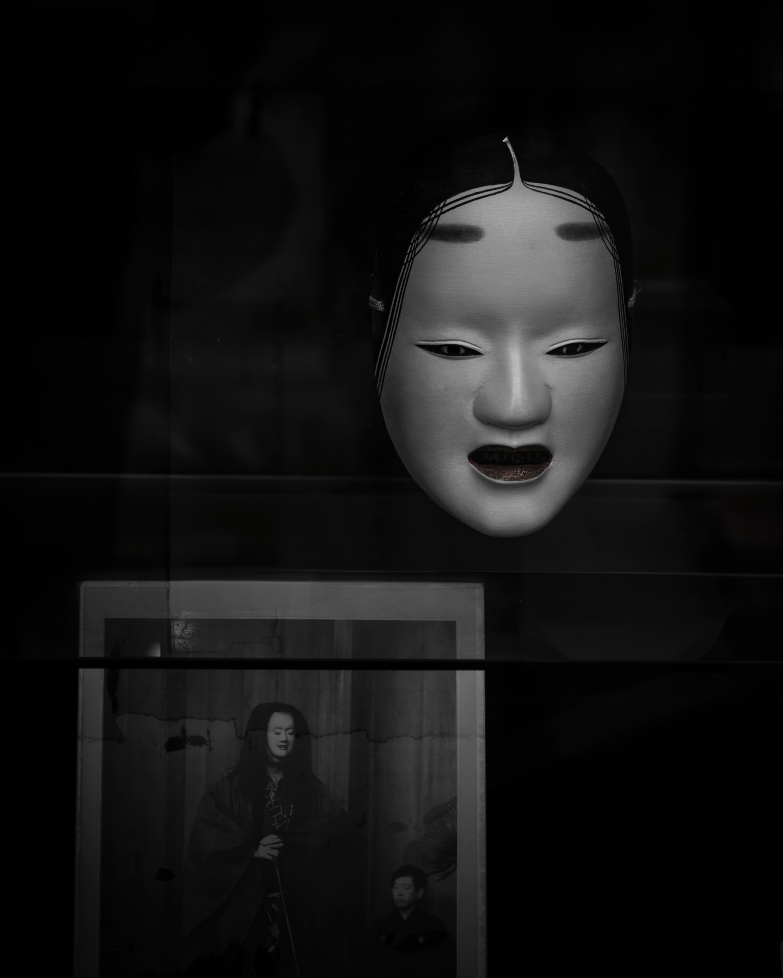 close-up of a mask face emerging from a dark background