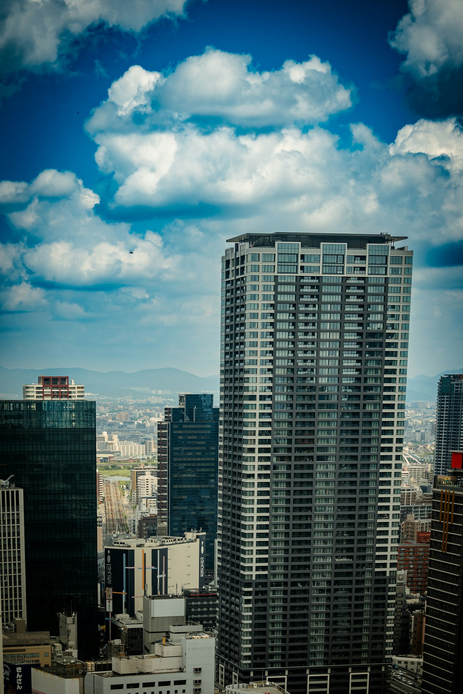Cityscape featuring a tall skyscraper and a blue sky