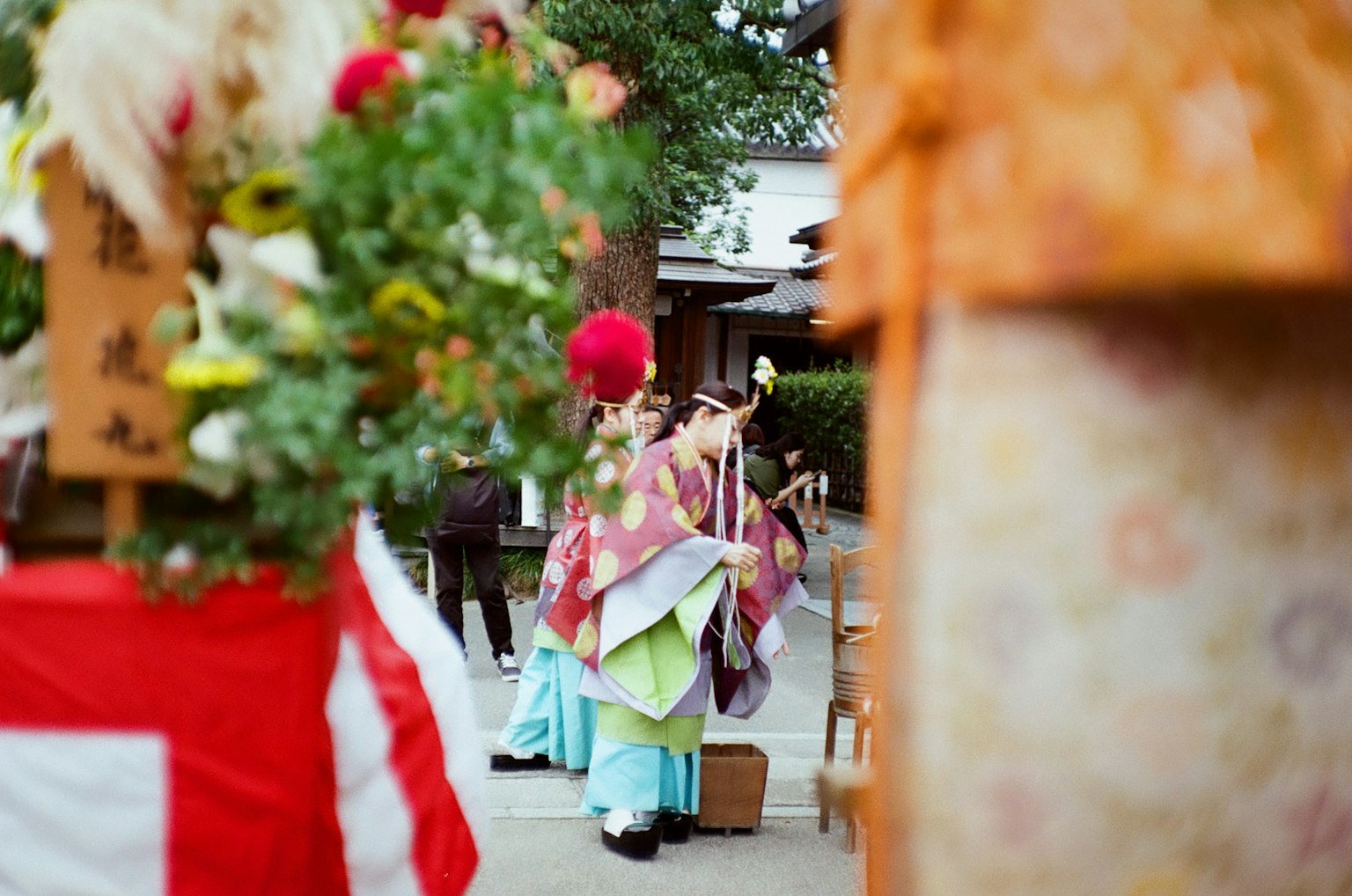 Traditional Japanese scene with colorful kimonos and floral decorations