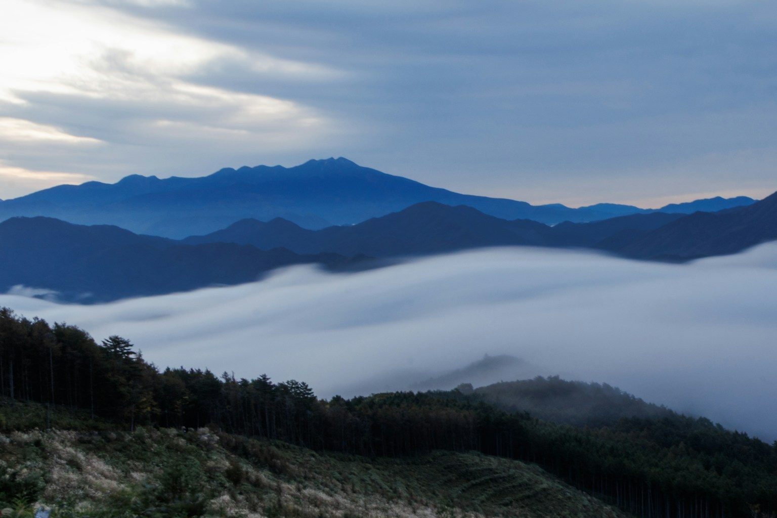 Blue mountains with valleys covered in mist