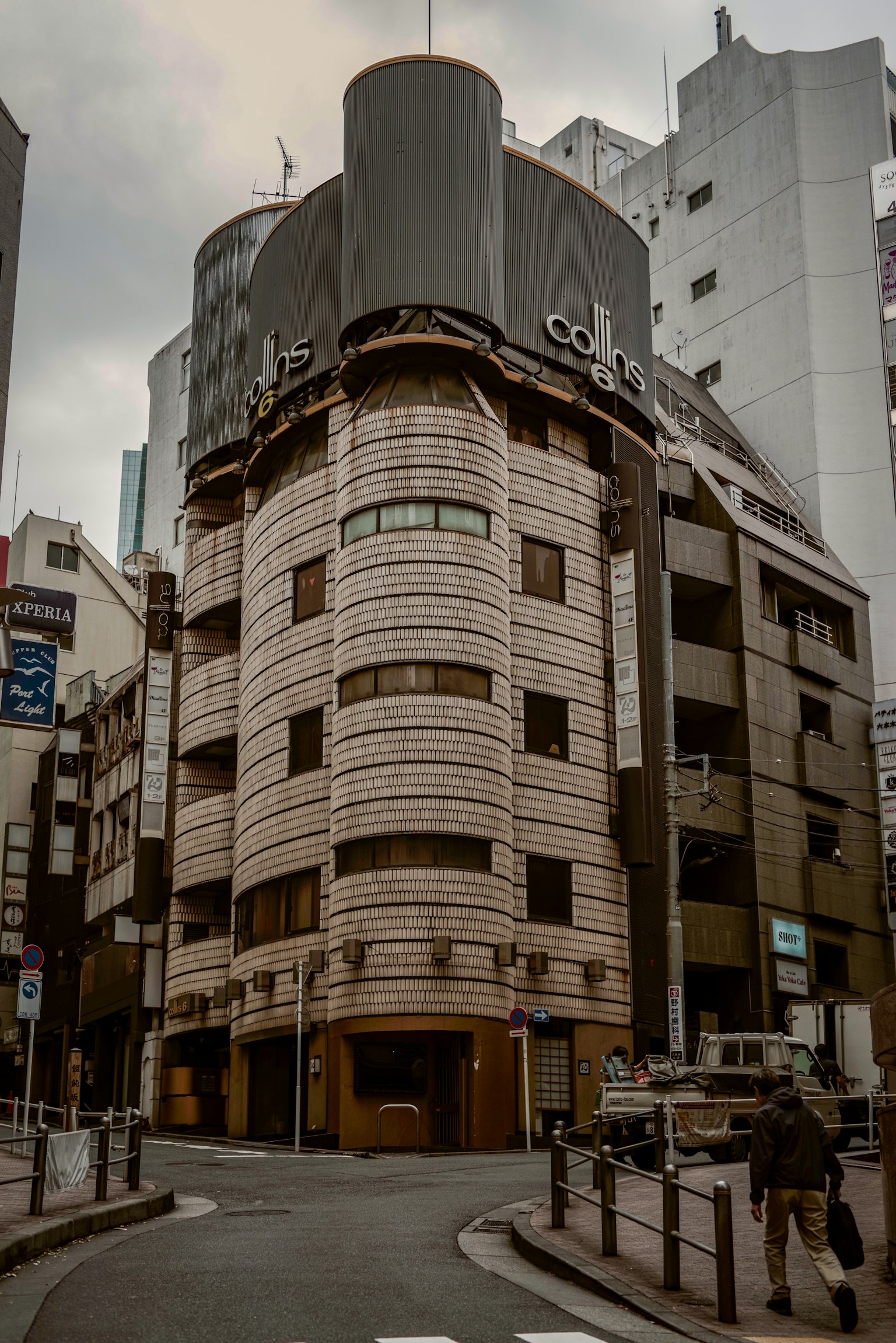 Street view featuring a unique building in Tokyo
