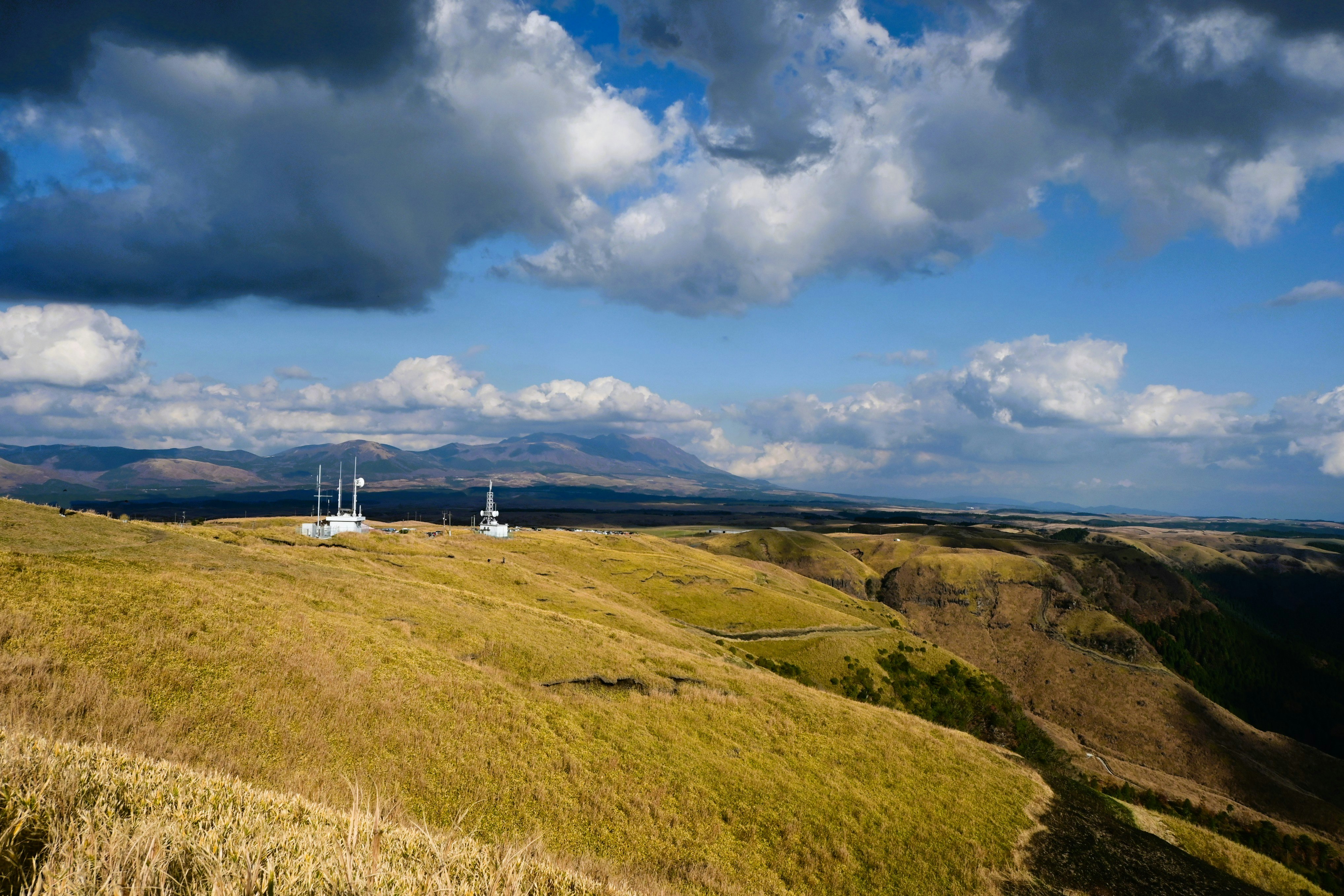 秋の阿蘇外輪山の草原と山並みの風景