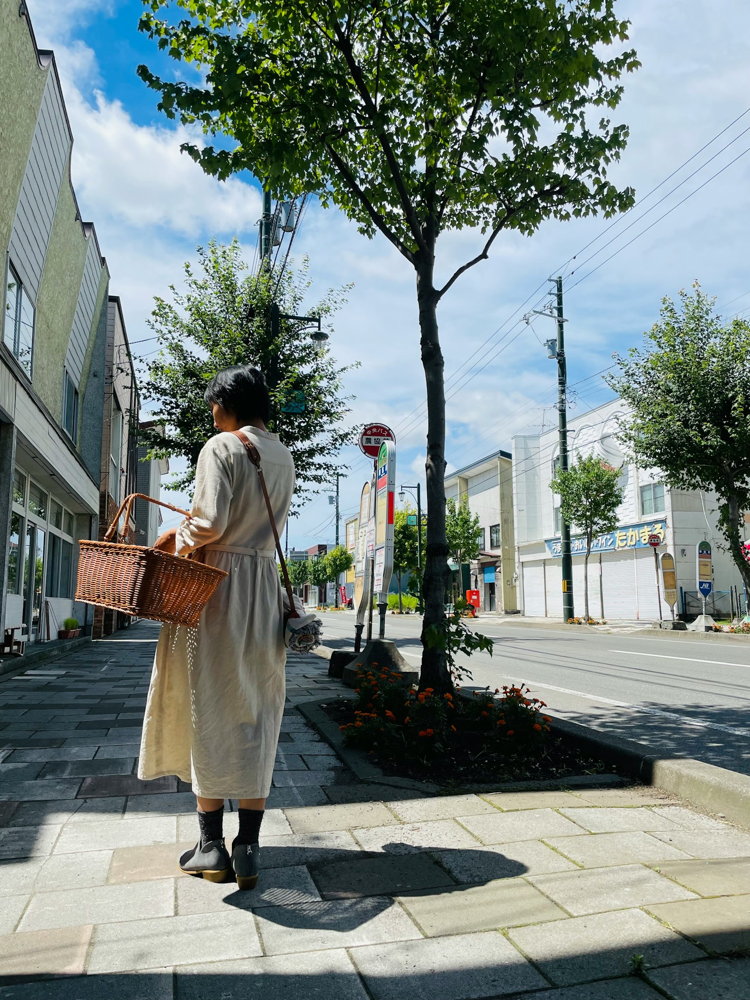 Woman walking on a street carrying a basket