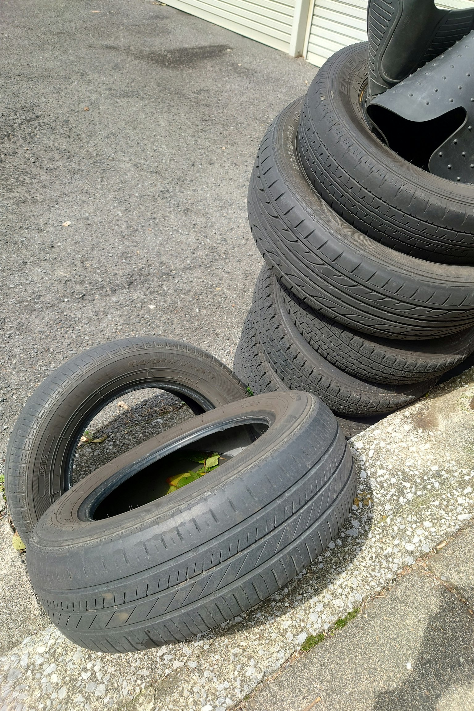 Stacked tires with one tire lying on the ground
