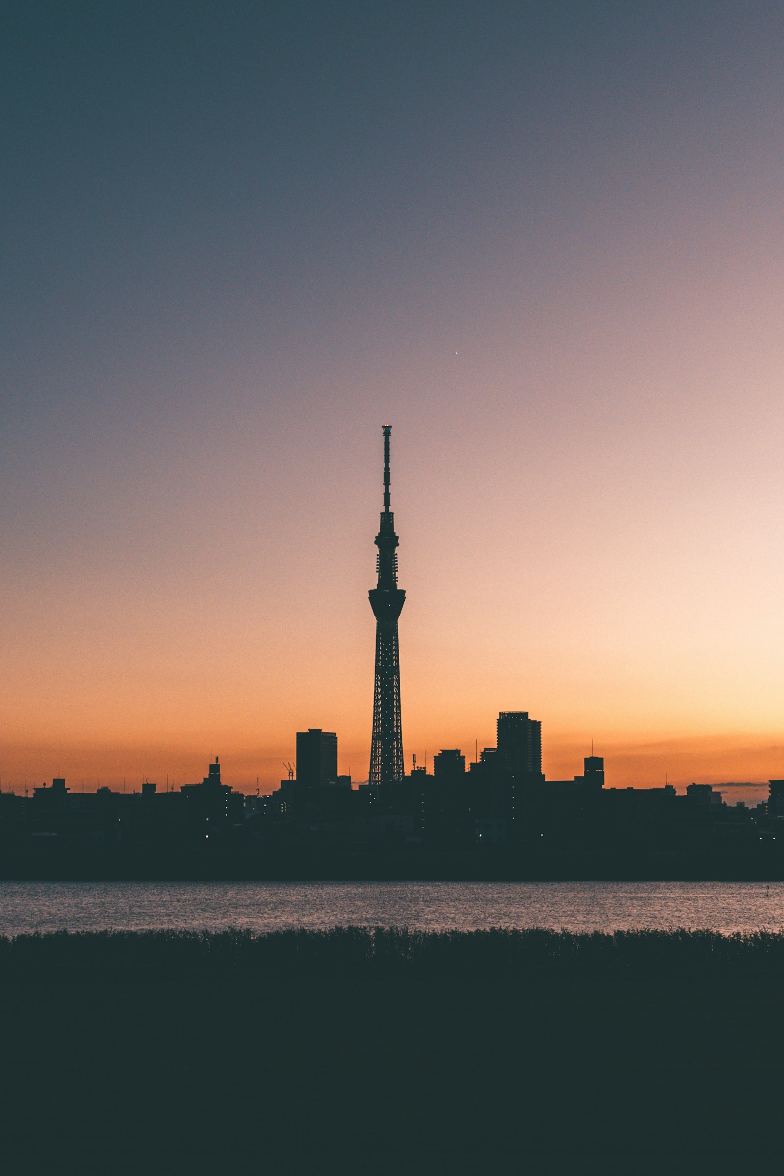 Silhouette of Tokyo Skytree against a sunset sky