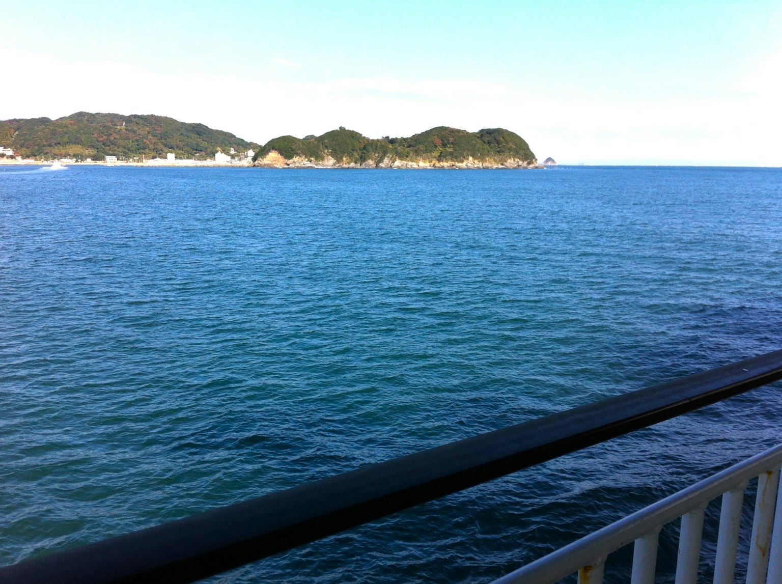 Scenic view of blue ocean and distant islands clear water surface and blue sky
