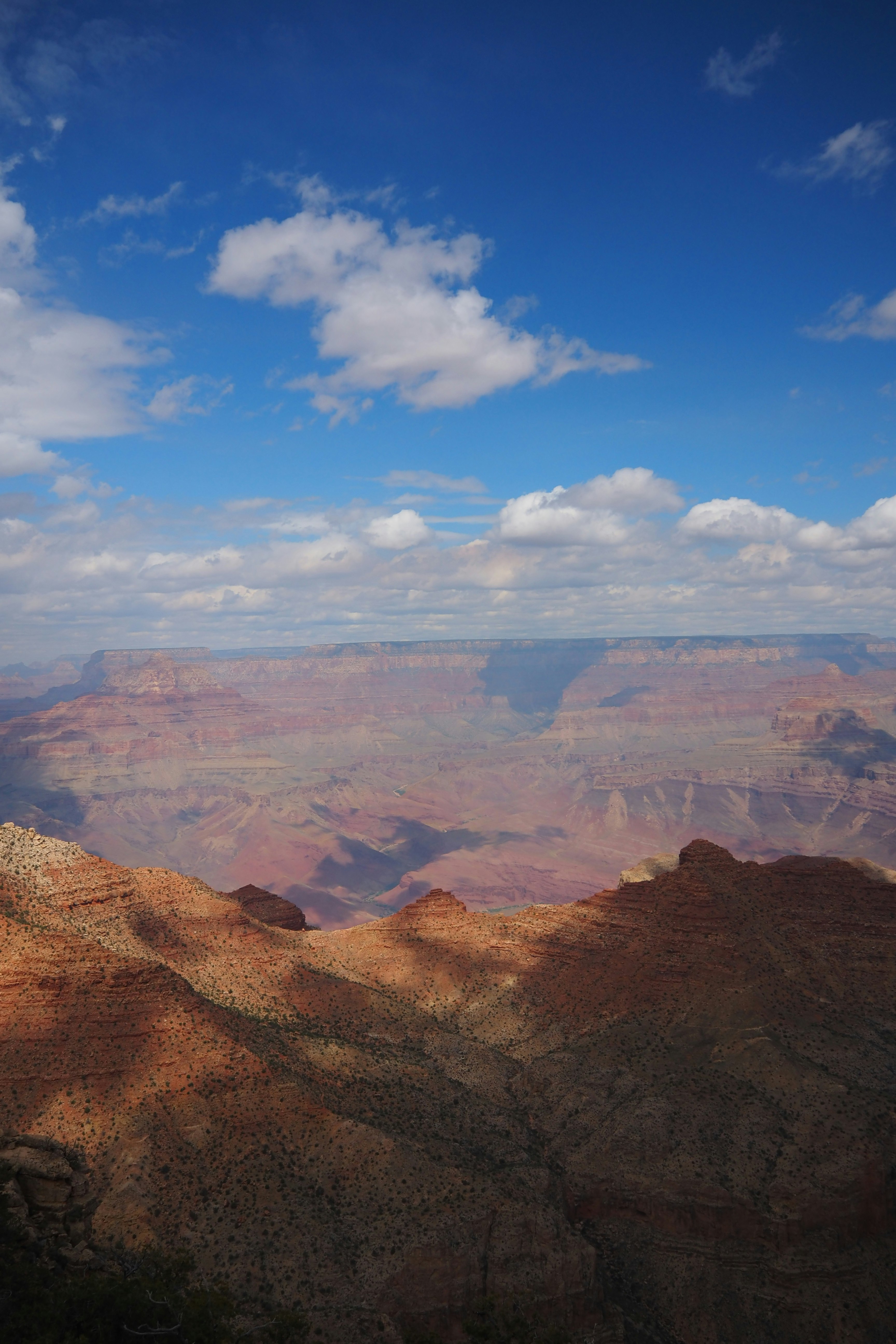Stunning view of the Grand Canyon with blue sky and clouds