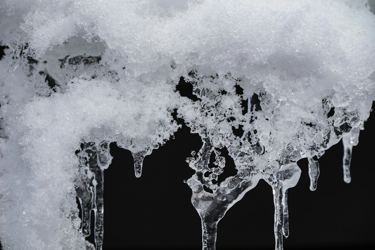 Eis- und Schneetextur, die sich von einem schwarzen Hintergrund abhebt