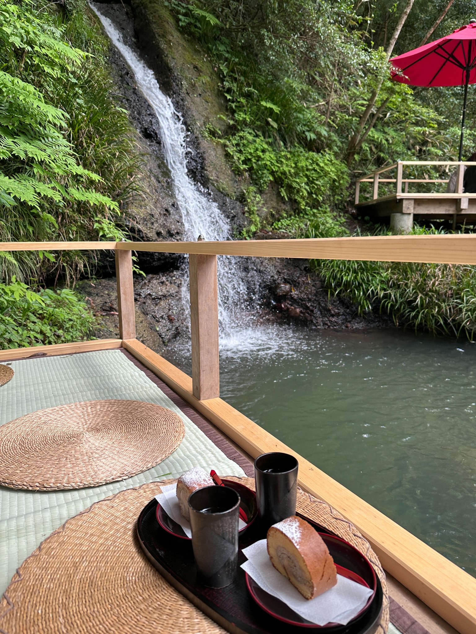 Set da tè giapponese con dolci vicino a una cascata