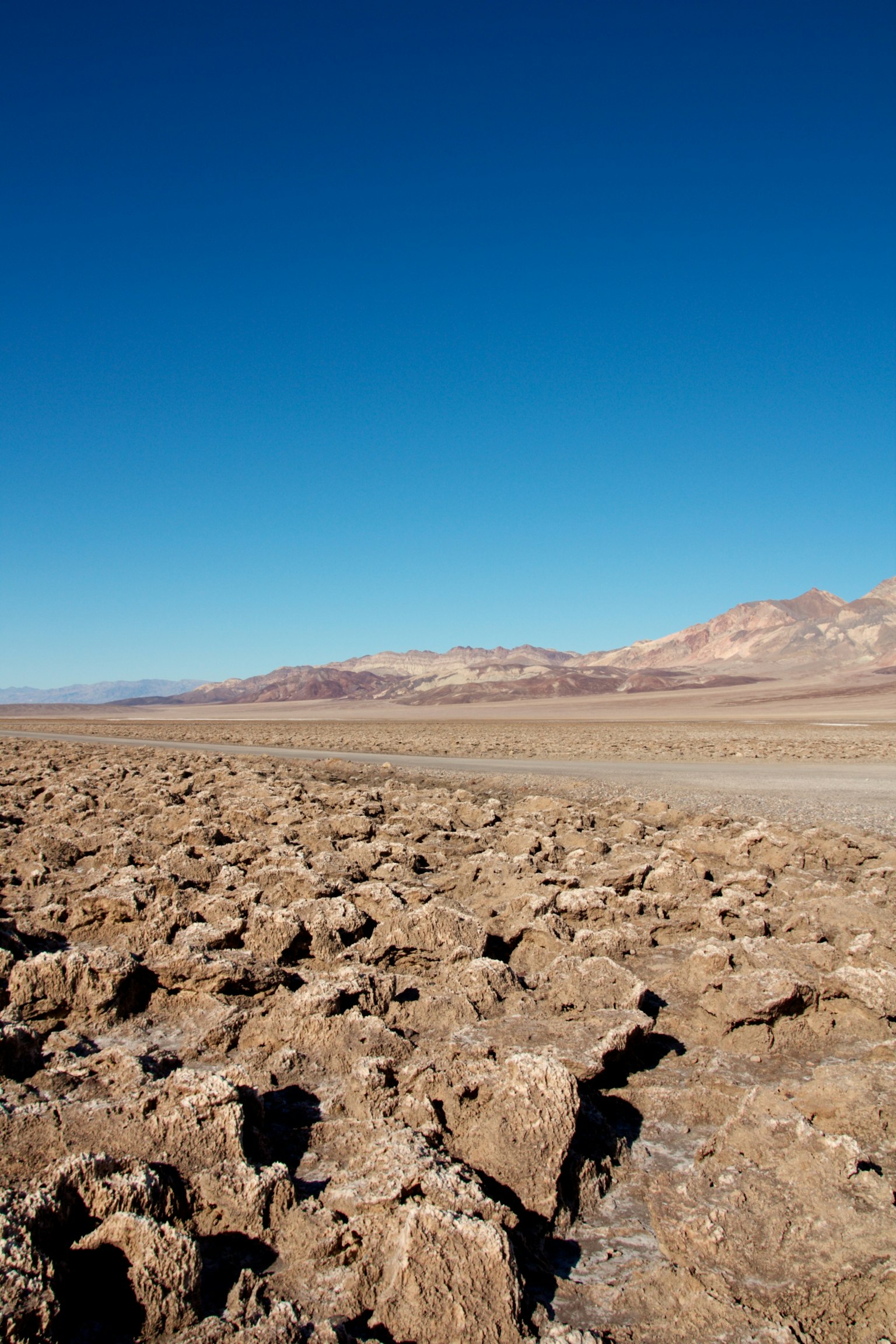 Arid landscape with rocky terrain and clear blue sky