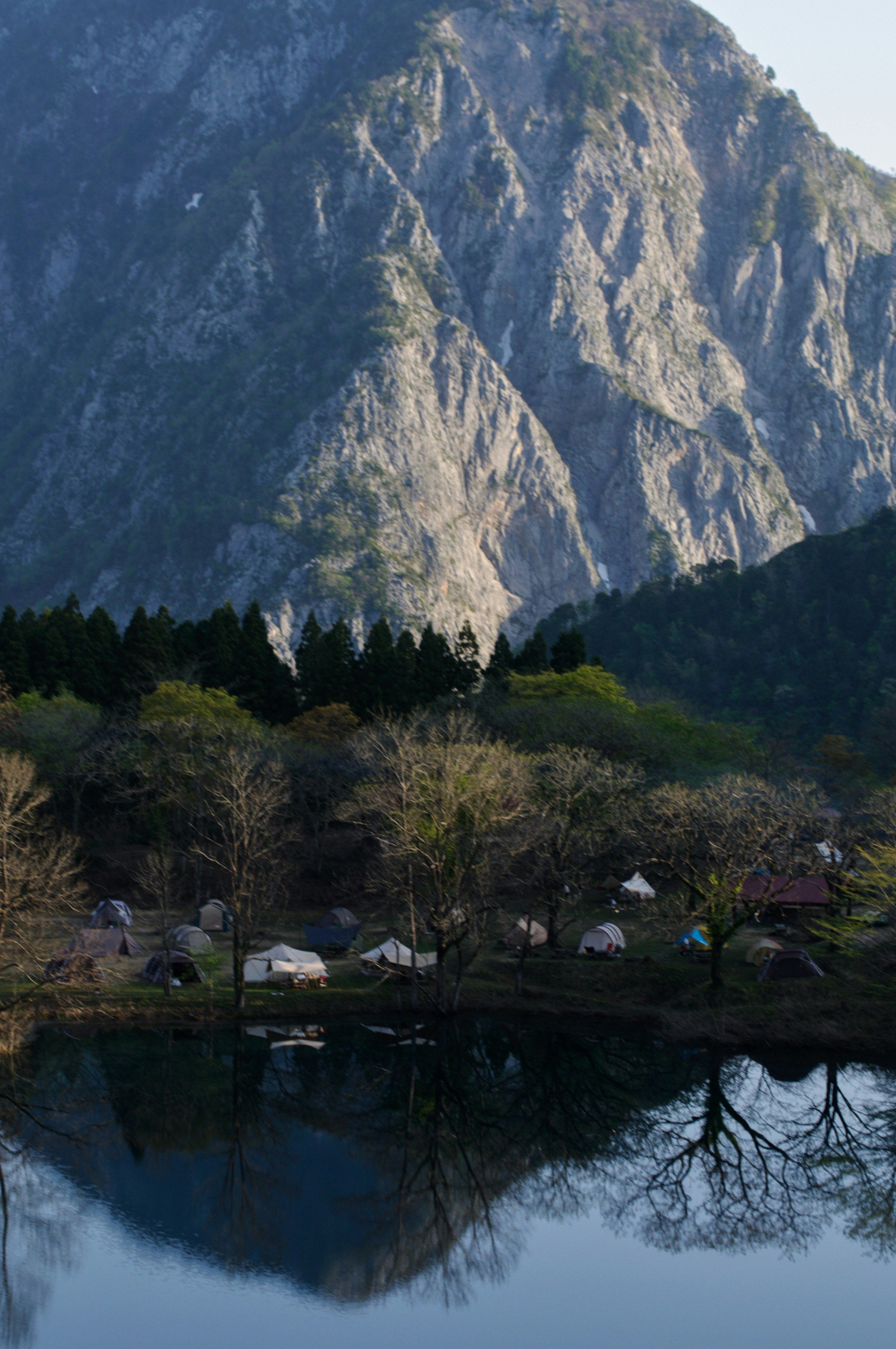 quiet garden by a lake with mountains reflected