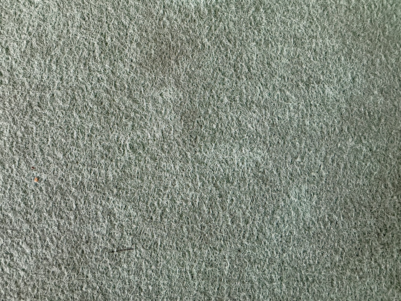 Surface de tapis vert avec texture et motifs subtils