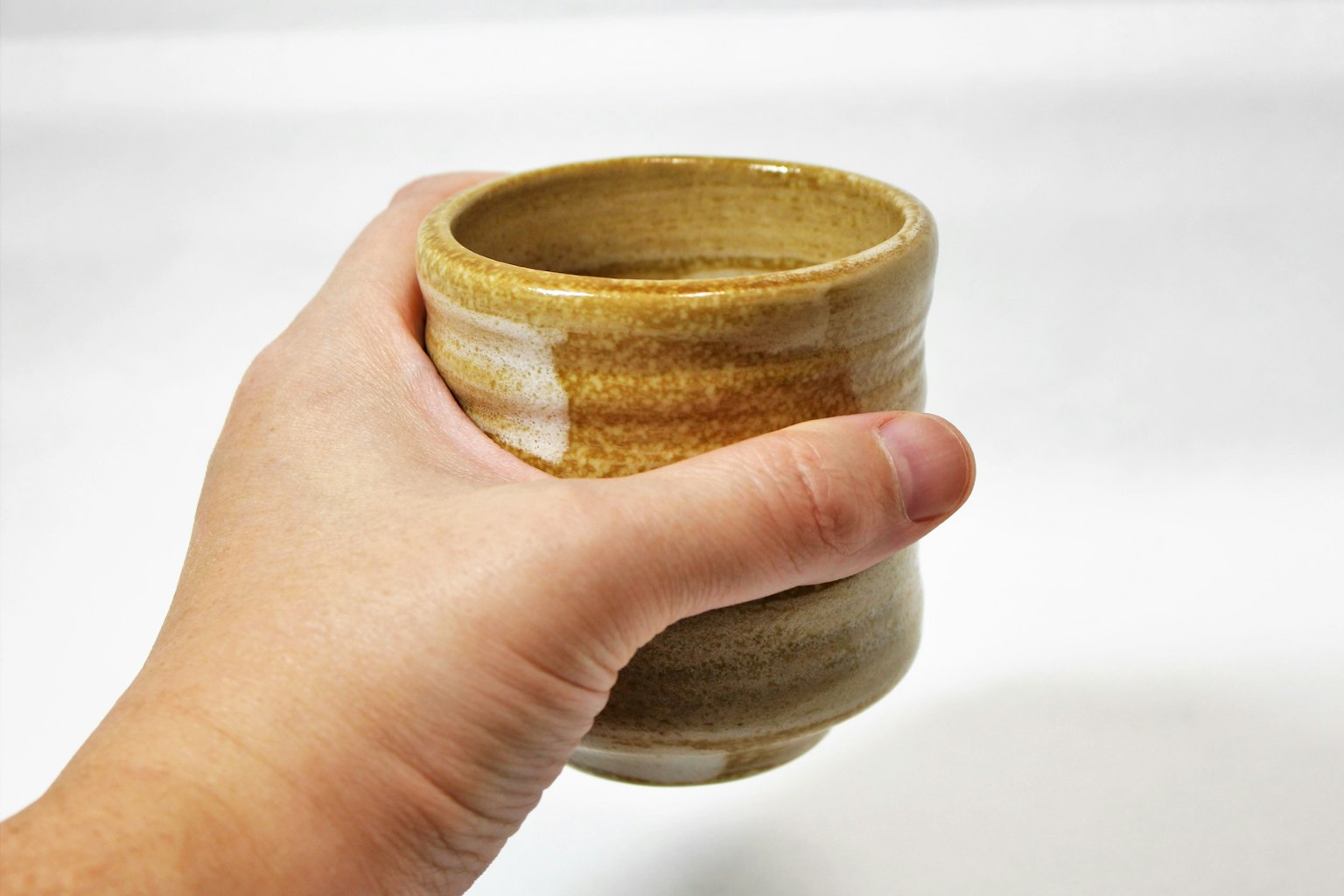 Close-up of a ceramic cup held in hand