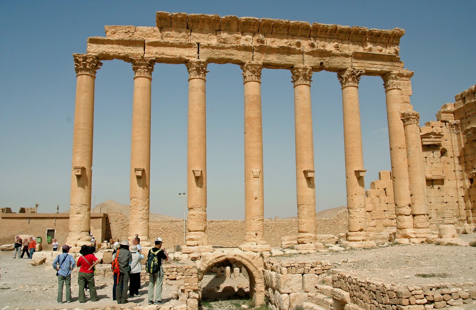 Tourists gathered around the ancient columns of Baalbek ruins