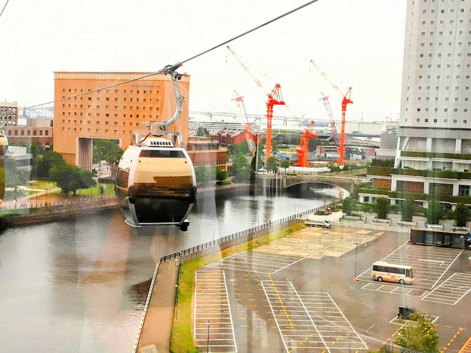 Seilbahn, die einen Fluss überquert, mit umliegenden Baukränen