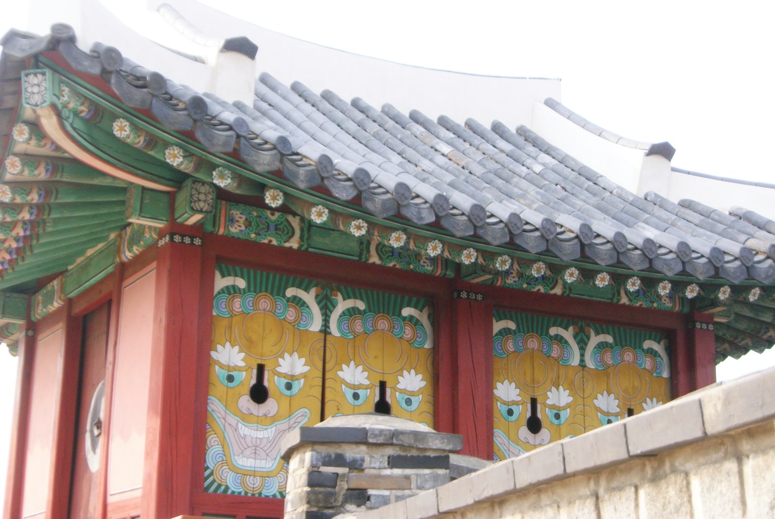 Traditional Korean building with ornate roof and lion paintings