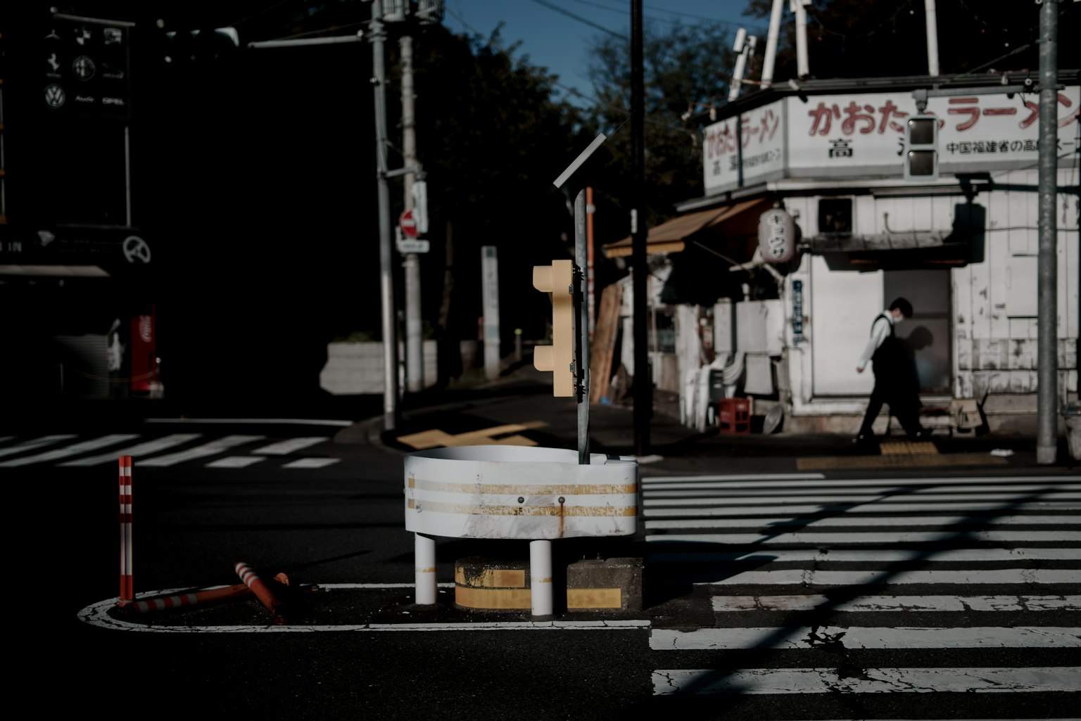 Intersection with a white building and crosswalk