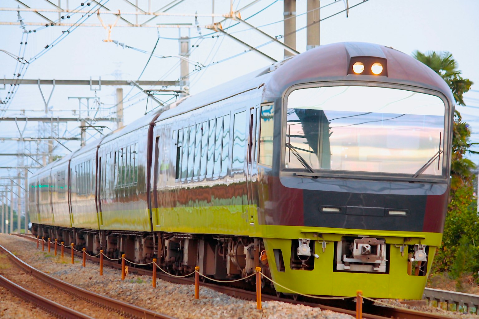 รถไฟที่มีลักษณะสีเขียวและสีแดงวิ่งบนราง