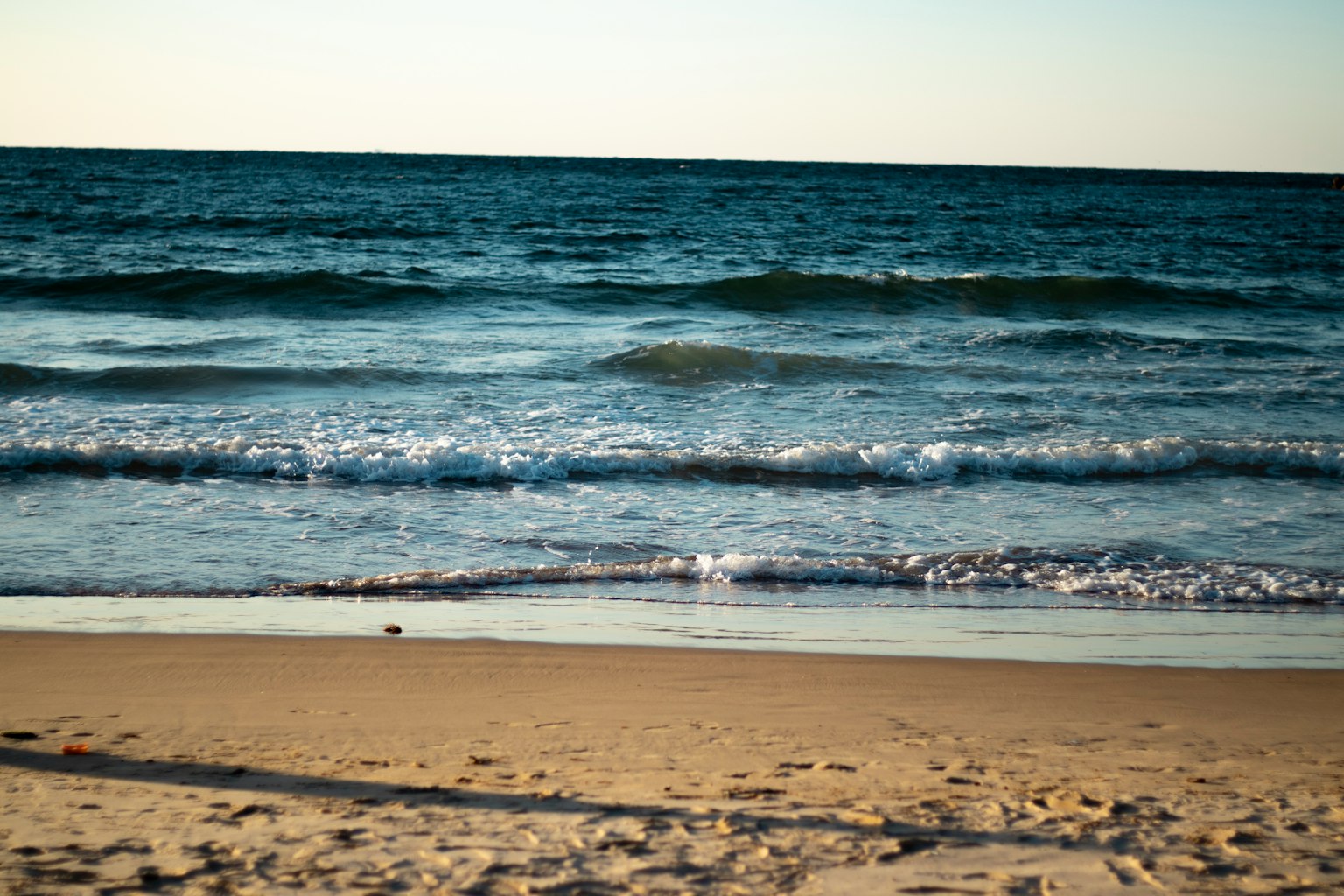Olas del océano y paisaje de playa de arena