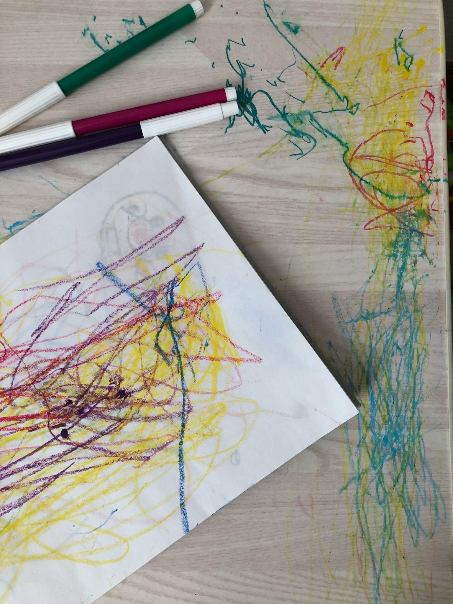 Colorful abstract drawing with markers on a table
