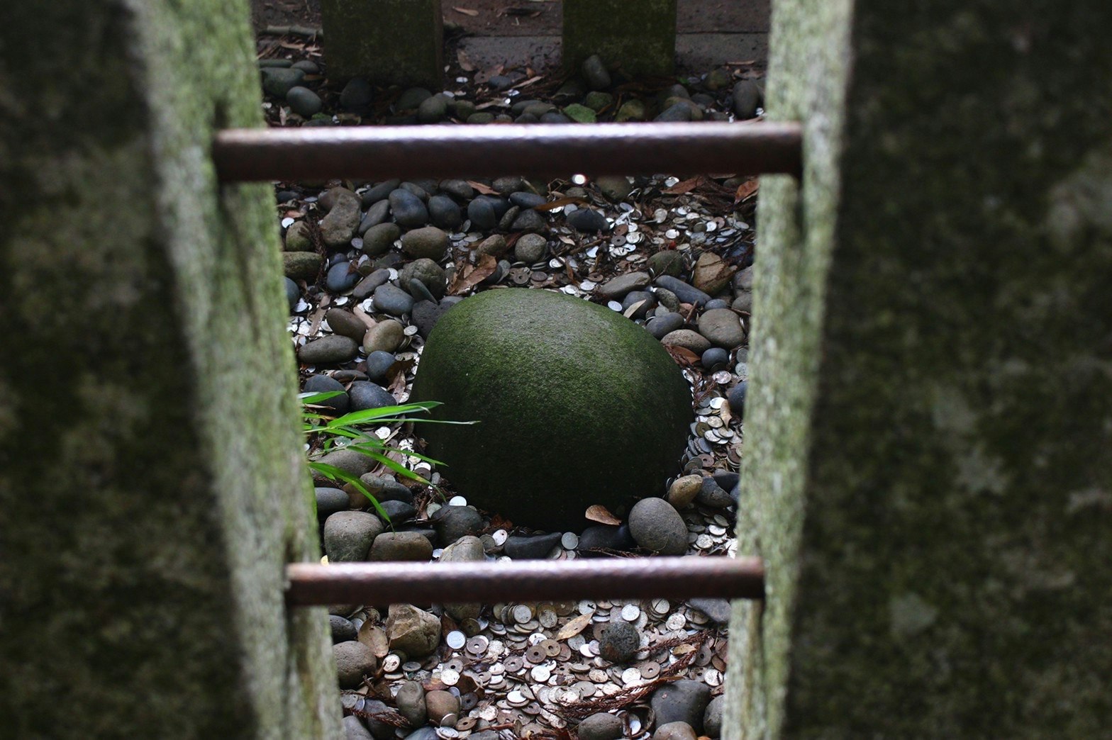 pequeño jardín de piedras con una figura protectora de piedra