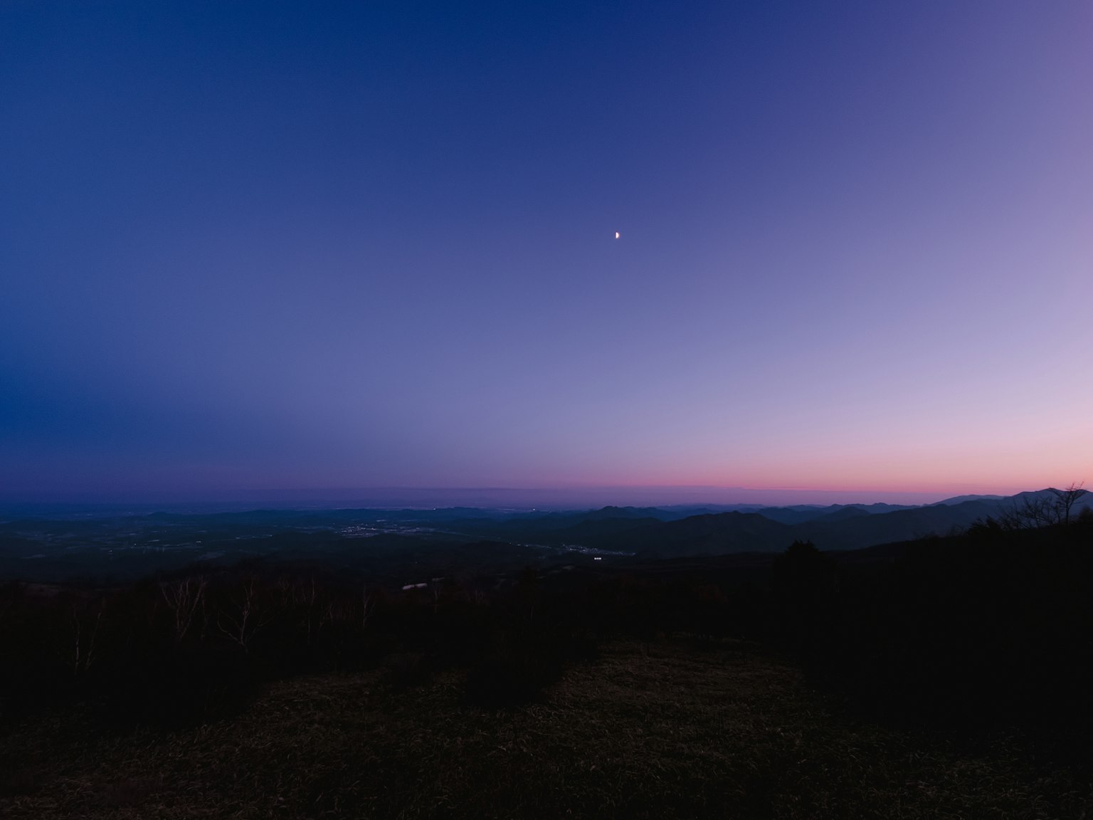 Twilight sky in shades of blue and purple with a small star visible