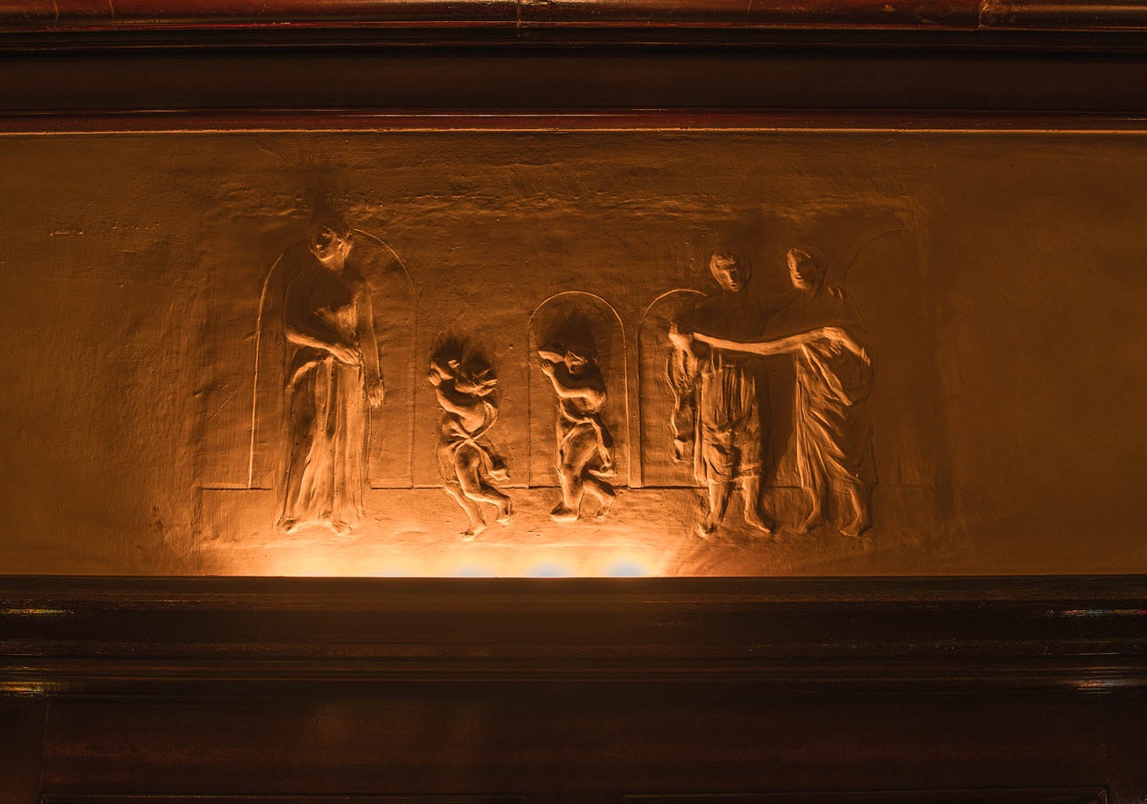 relief sculpté sur un mur avec personnages