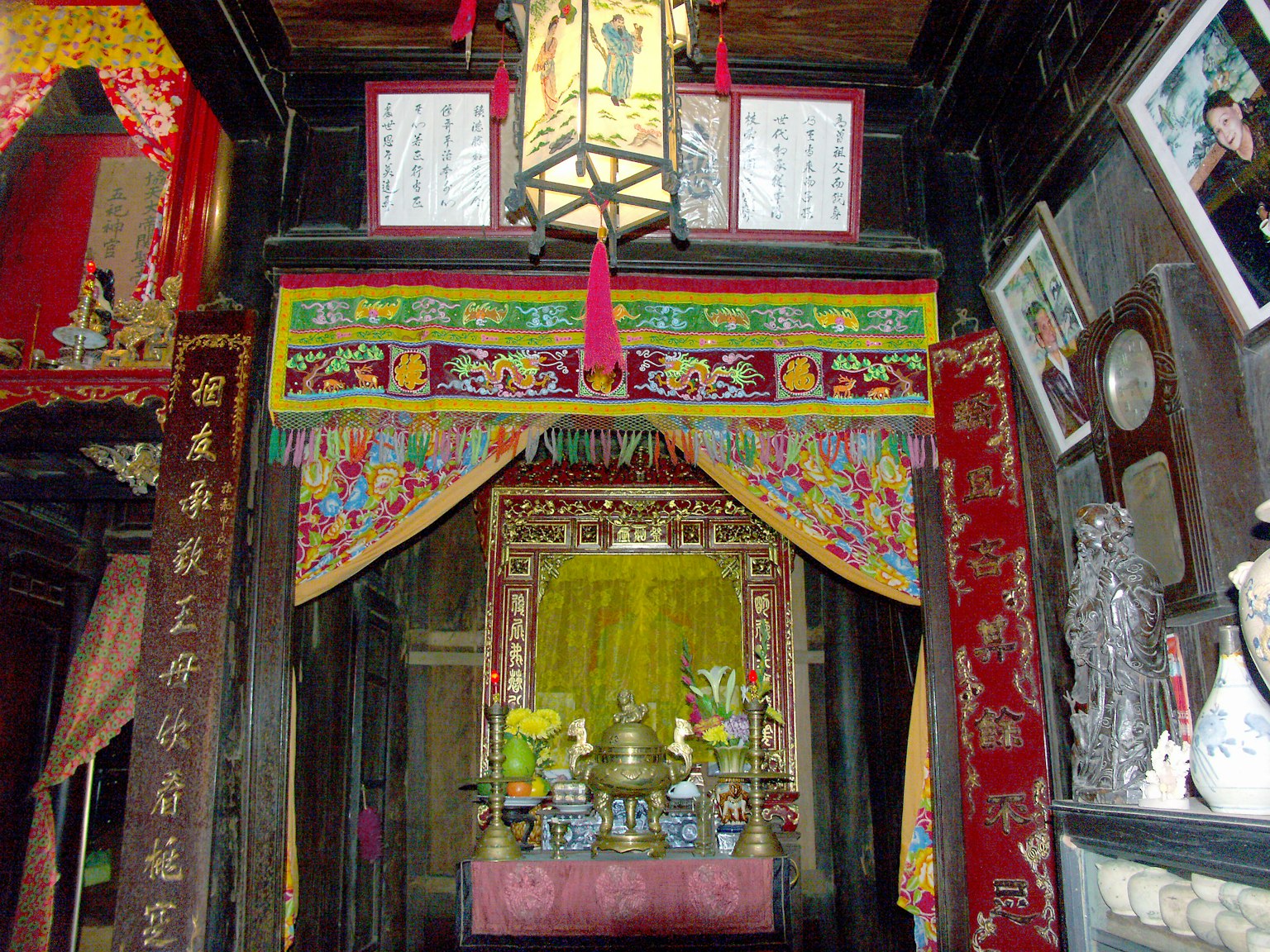 Traditional temple interior decoration colorful curtains ornate lanterns altar with offerings