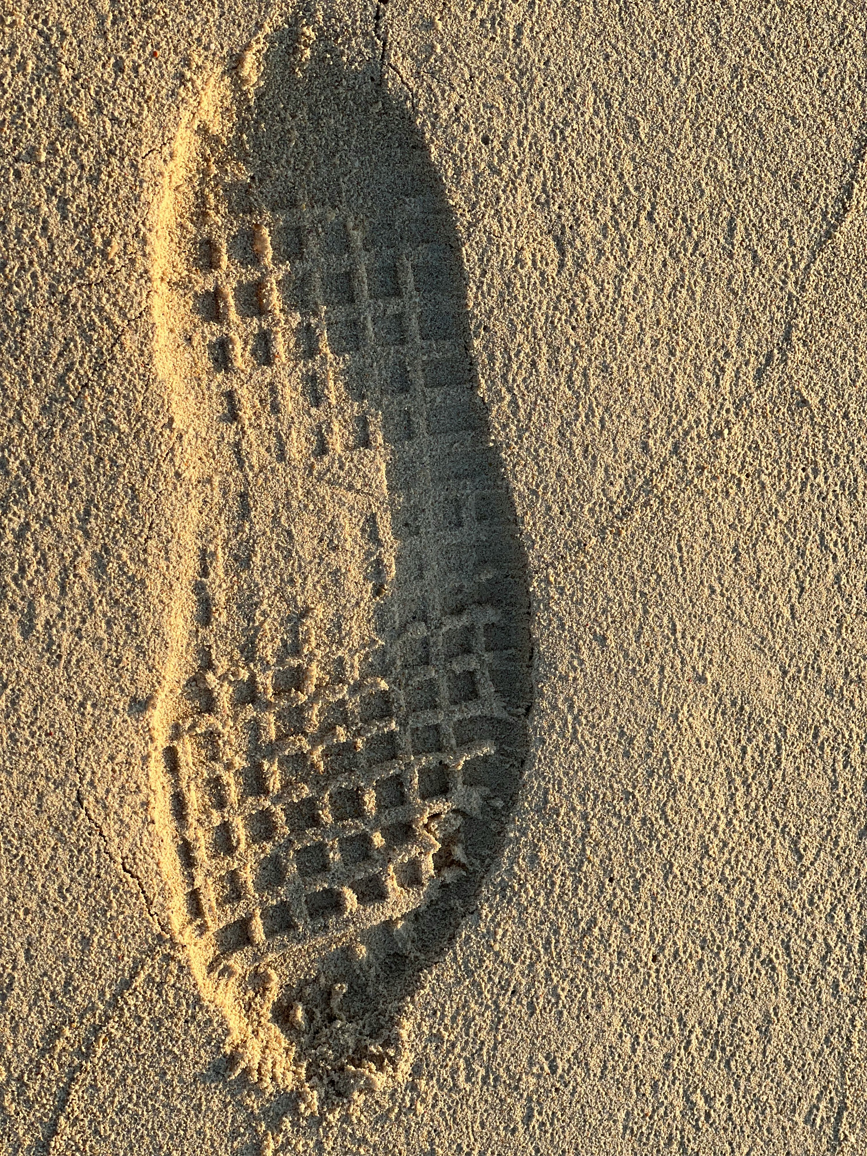 footprint shadow in sand