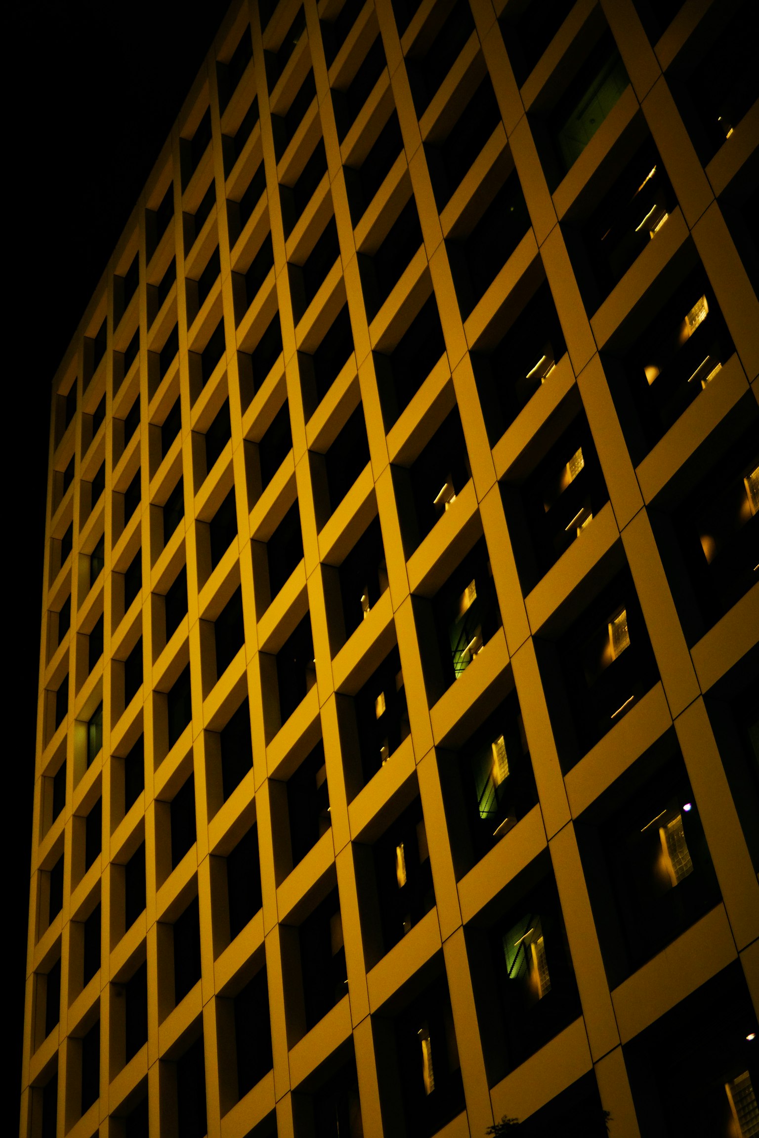 Detailed view of a grid pattern on a building's facade at night