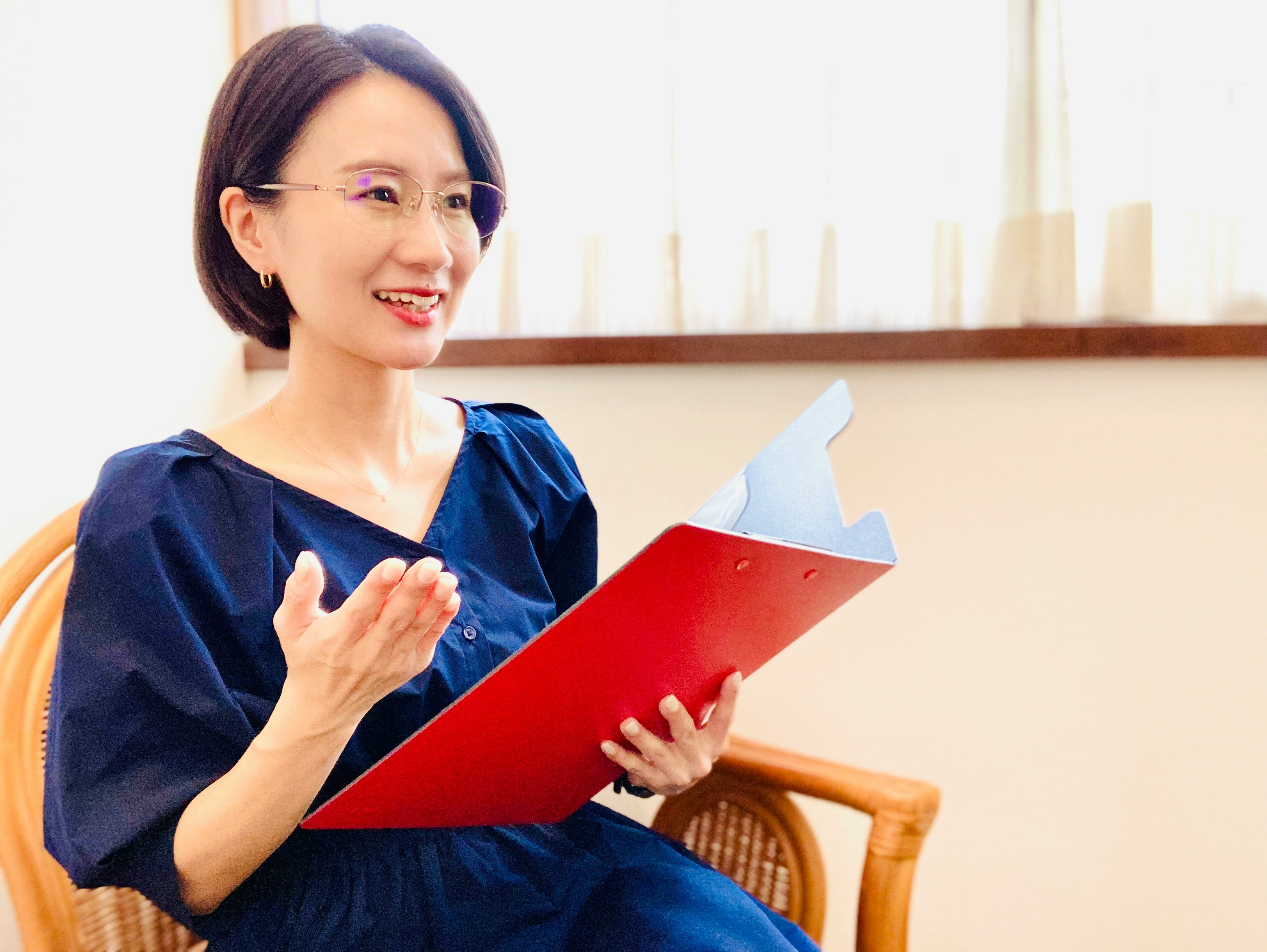 woman sitting on a chair holding a book