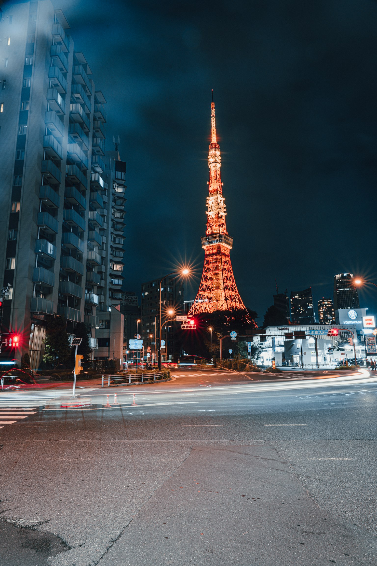 Tokyo Tower illuminated at night with surrounding buildings