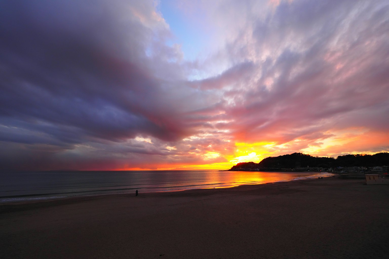 Dramatic sunset over the coastline with vibrant clouds