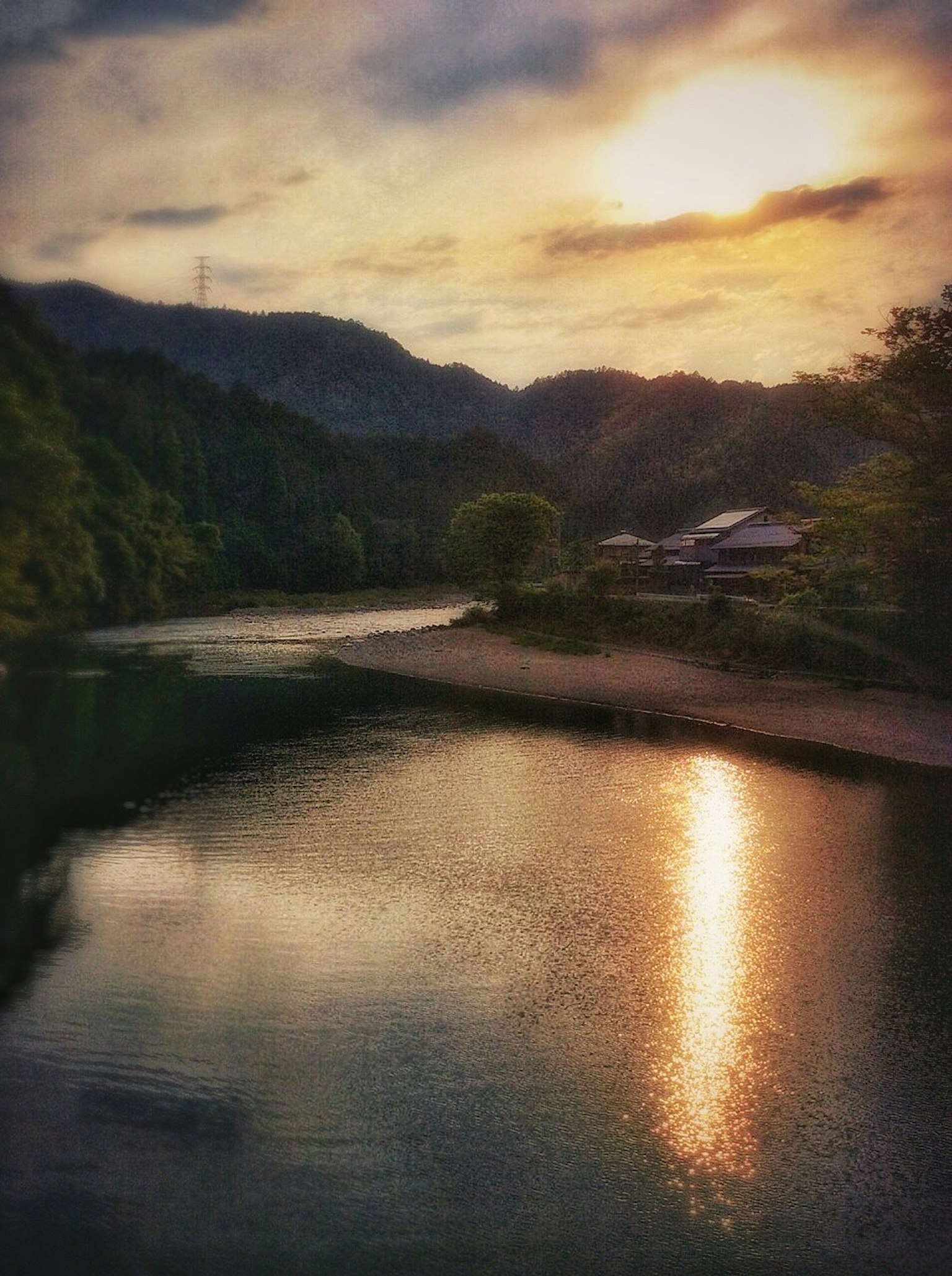 Serene river landscape with sunset reflections and mountains