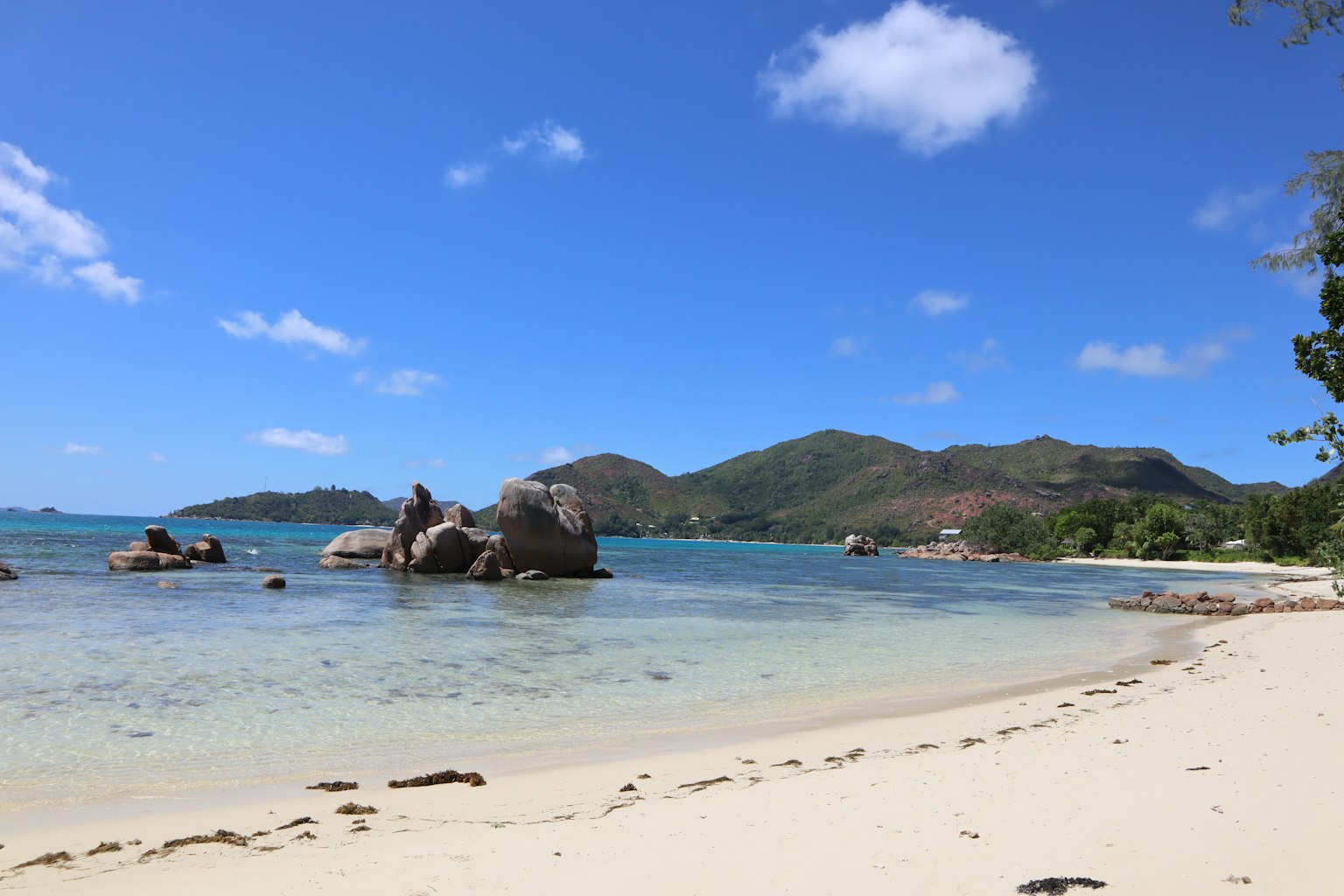 Scenic beach view with blue sky and white sand