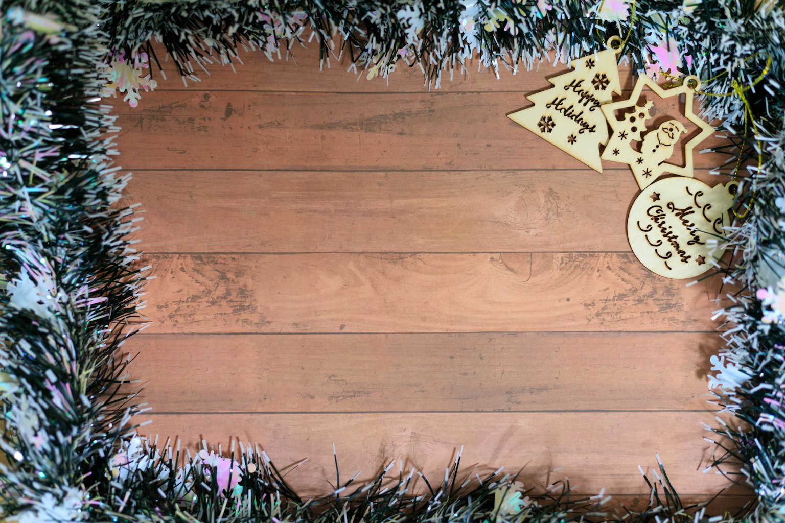 A wooden surface decorated with floral elements and Christmas ornaments