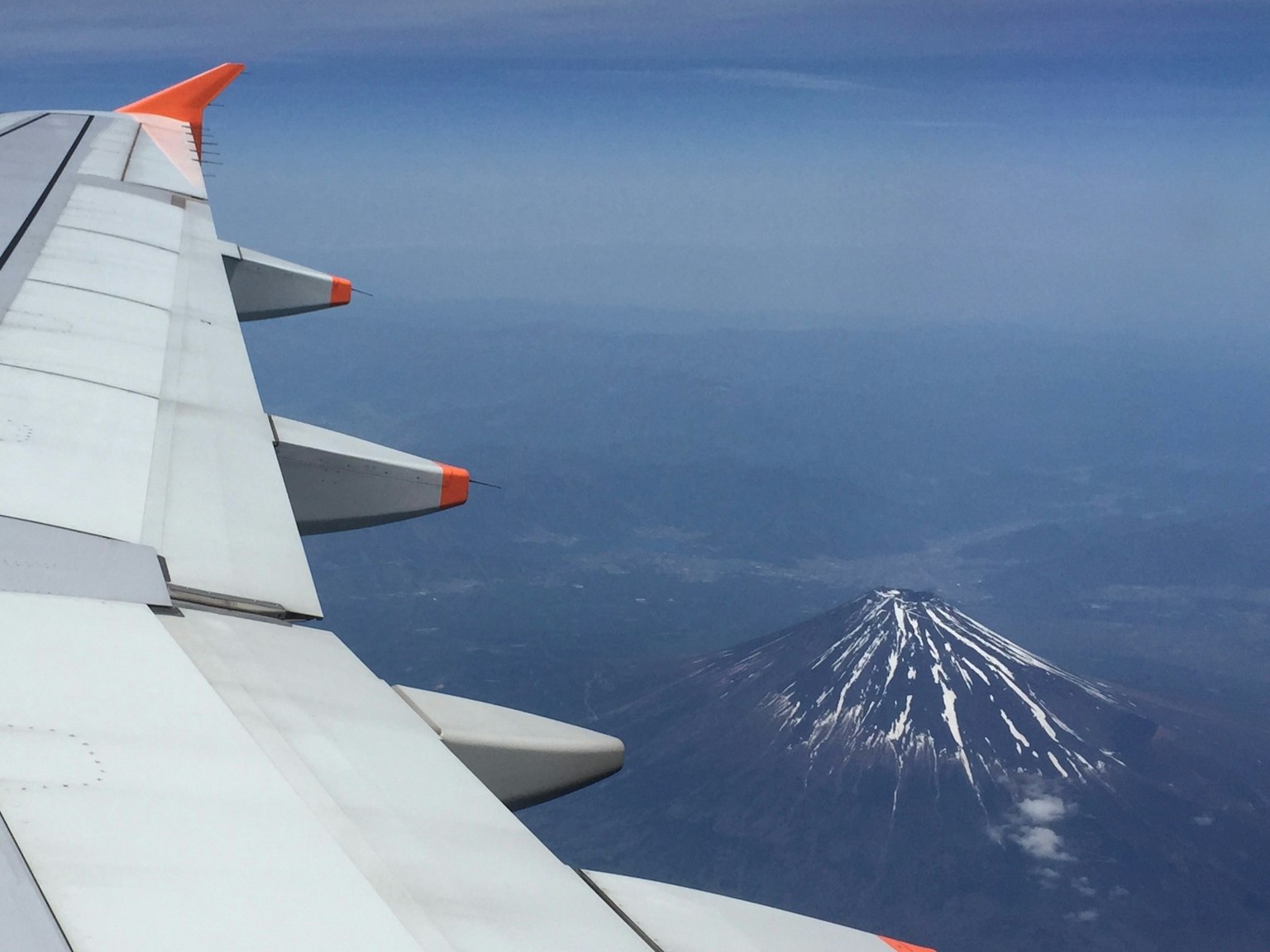 Scenic view of Mount Fuji seen from an airplane wing