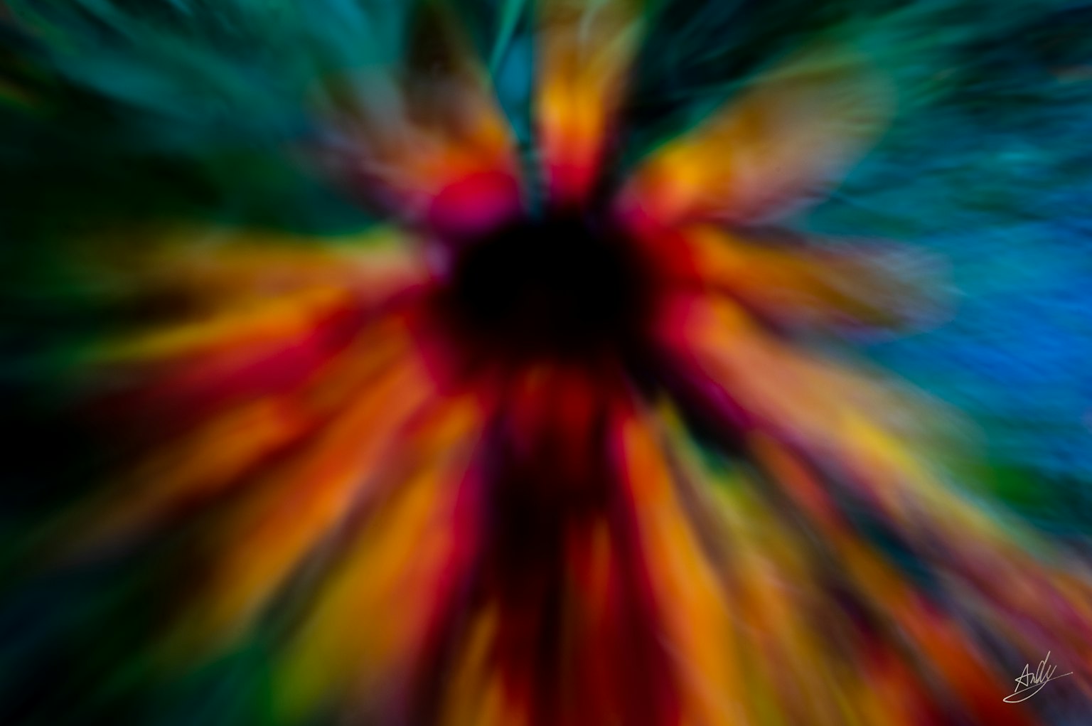 Immagine astratta con colori vivaci che si irradiano da un centro scuro