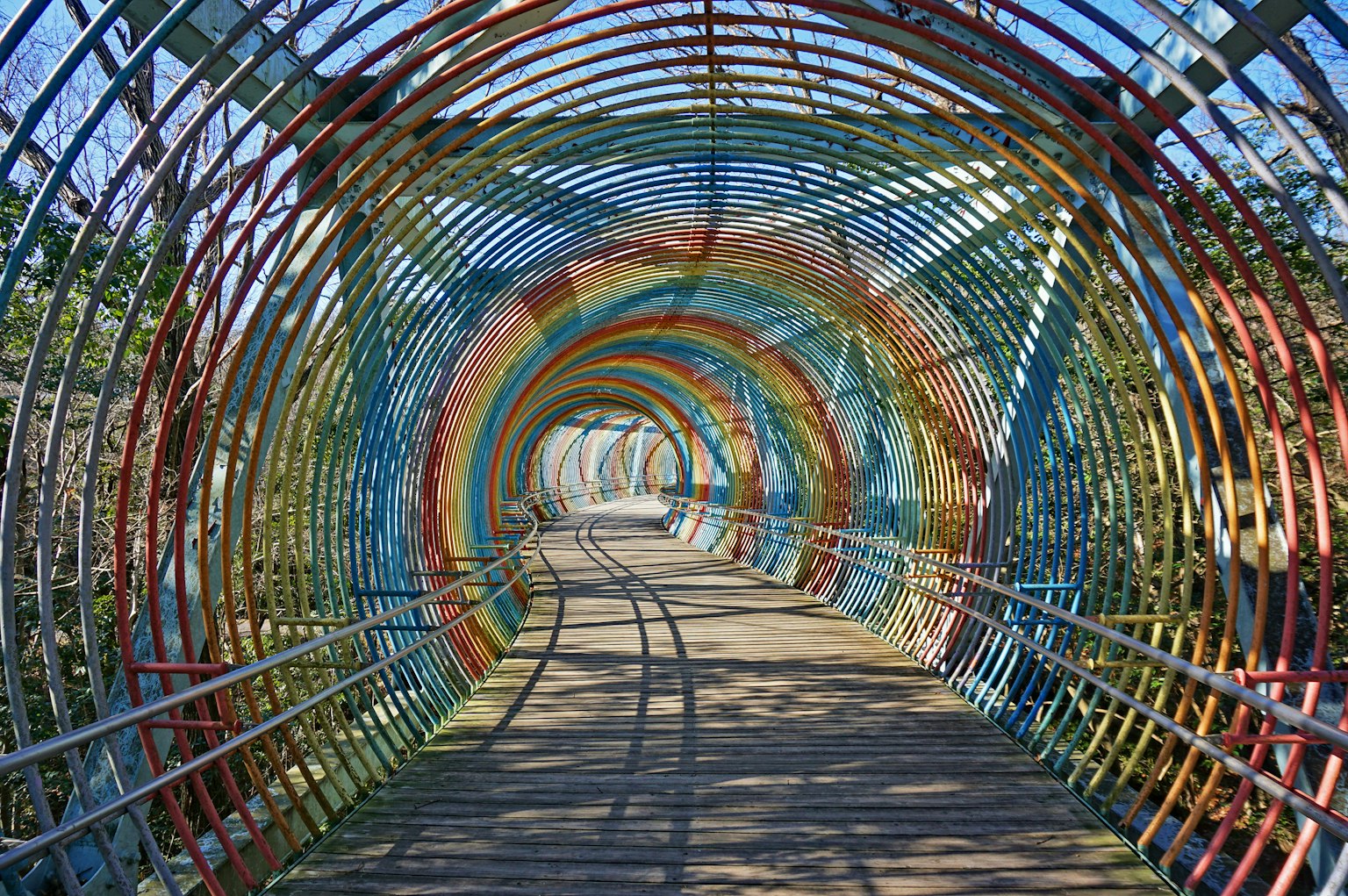 Colorful tunnel-shaped pedestrian bridge interior