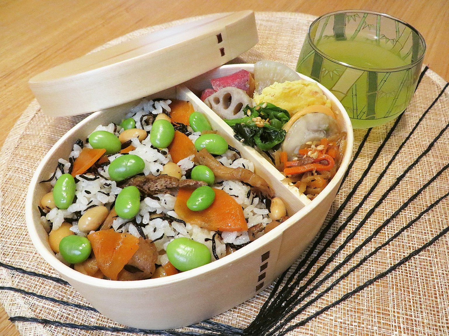 Kotak bento kayu penuh dengan nasi berwarna dan lauk