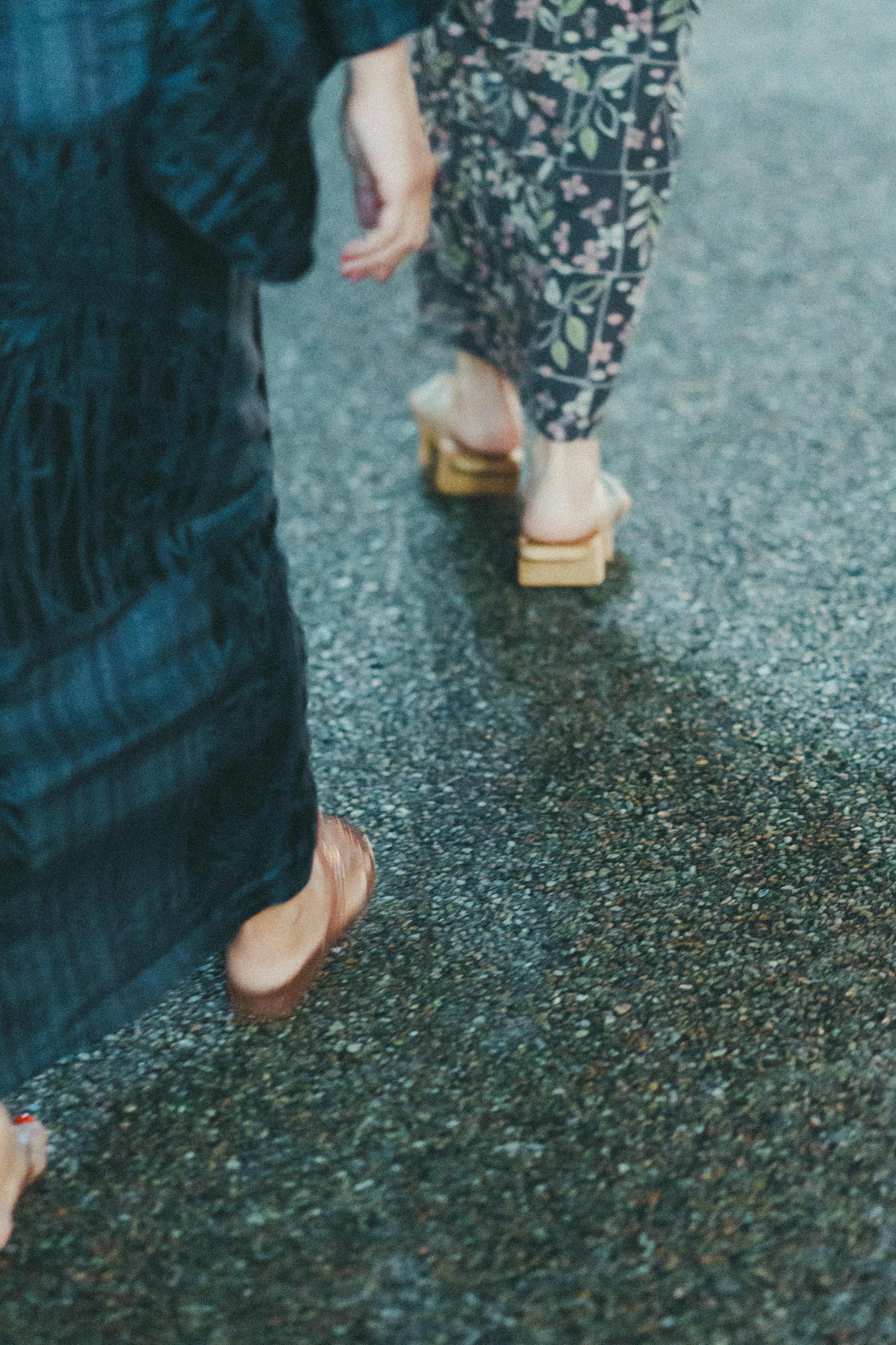 People’s feet walking on a street with sneakers