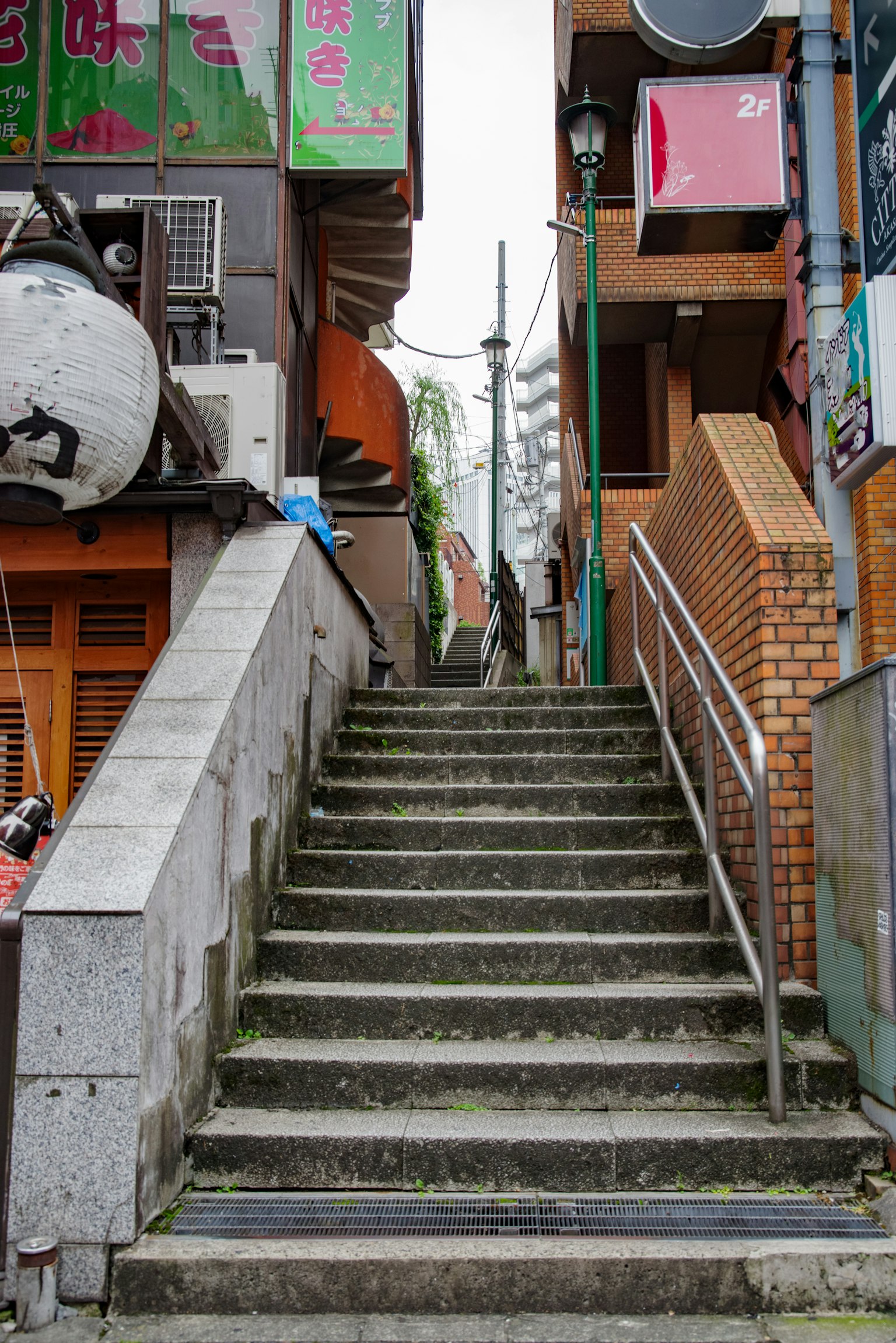 Stairway leading up with colorful signs and urban buildings