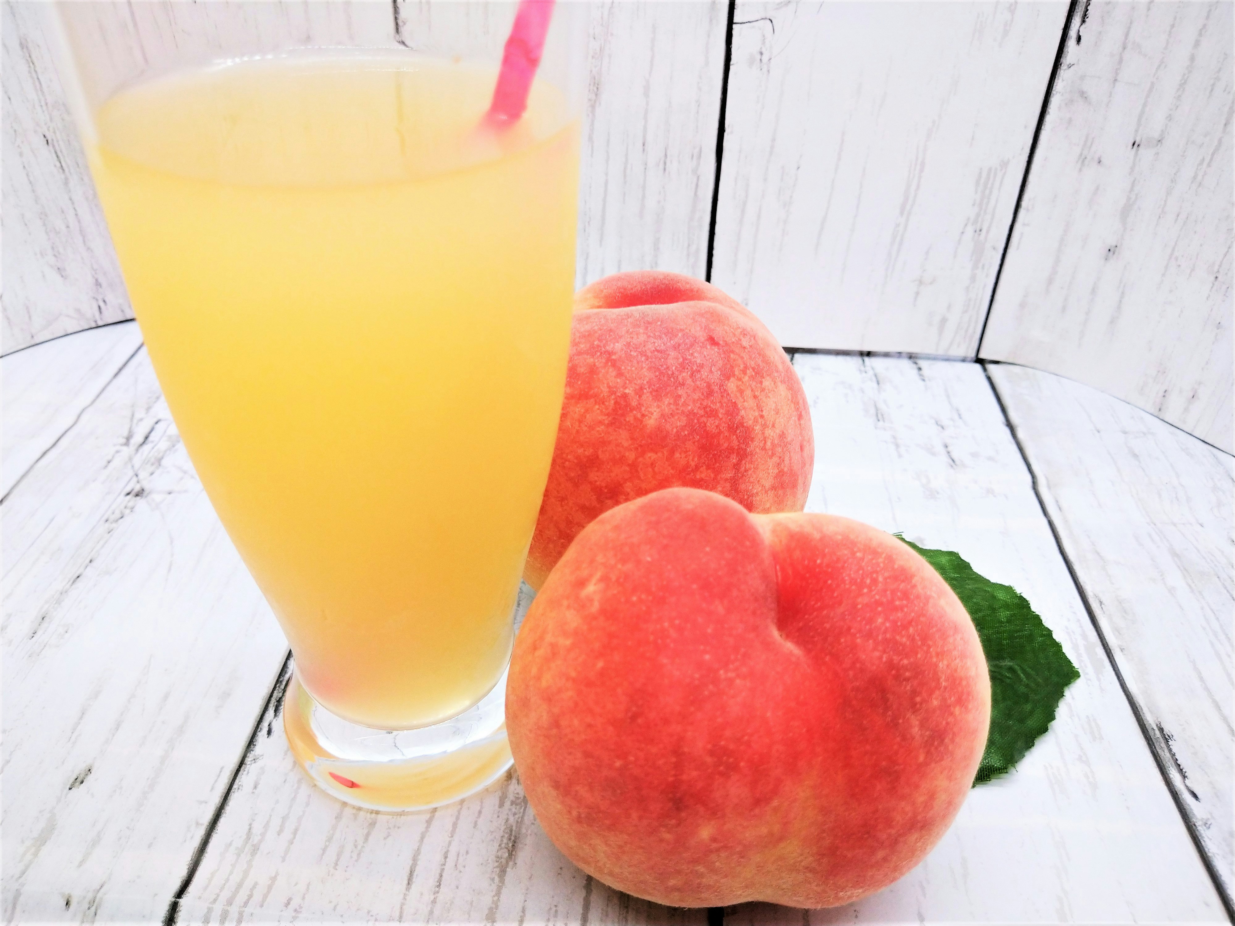 sliced peaches and orange juice on a table image