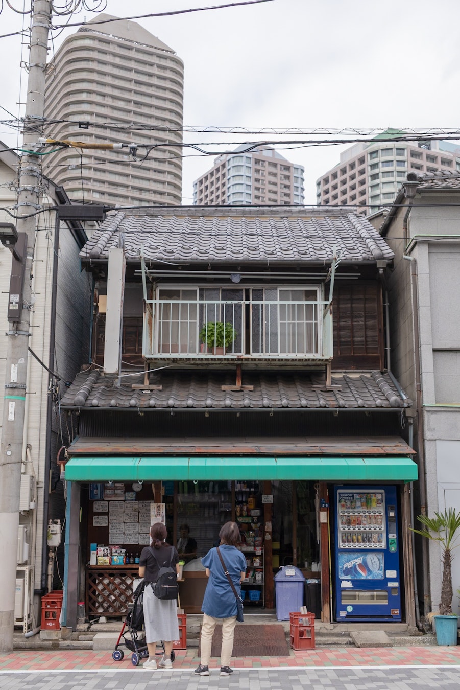 Shops along a narrow alley in Tsukuda with bicycles
