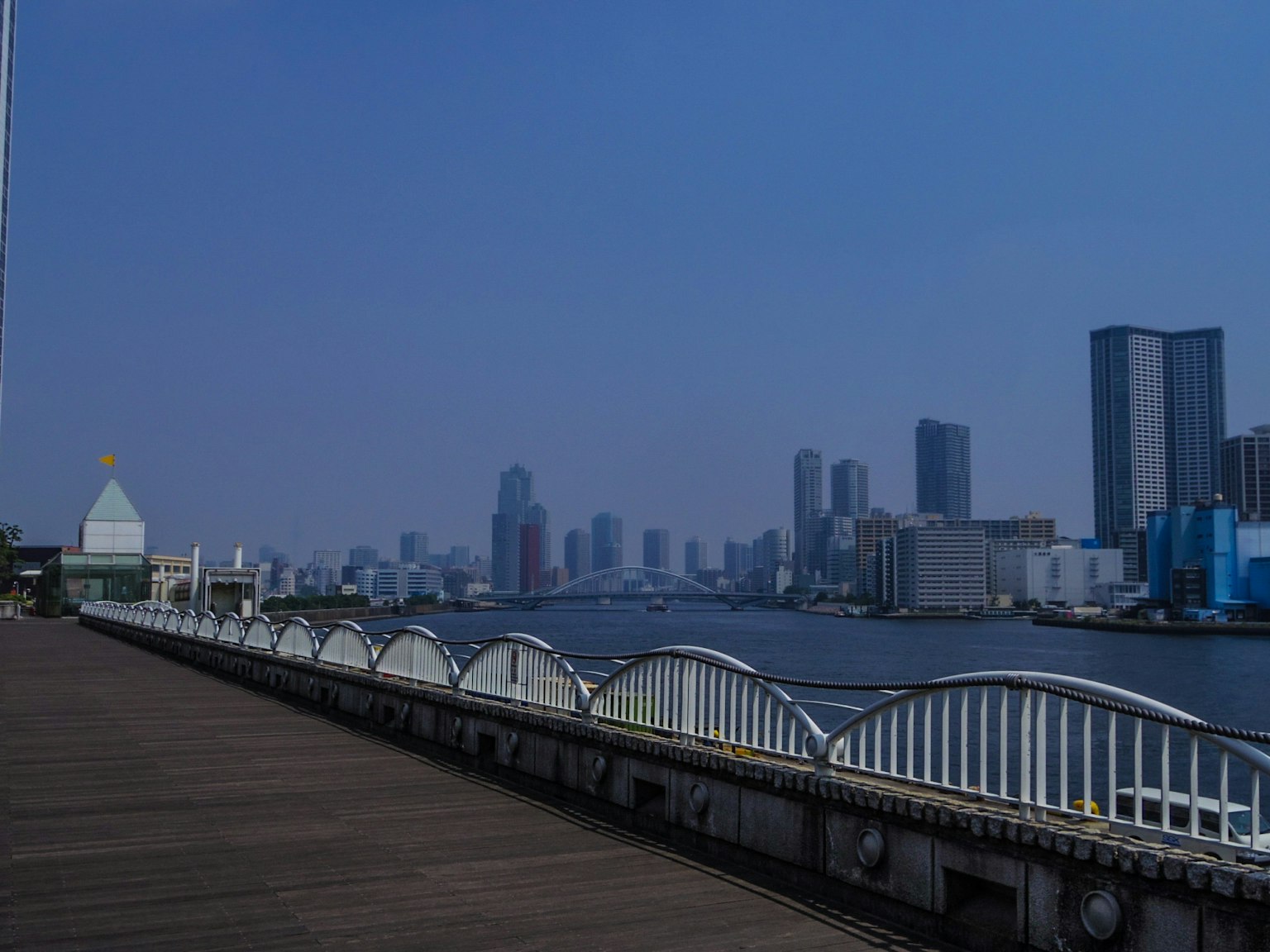 Urban skyline with a river under a blue sky