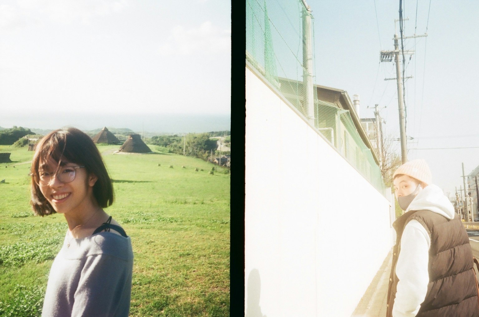 A woman smiling under a blue sky and another woman turning back in front of a white wall